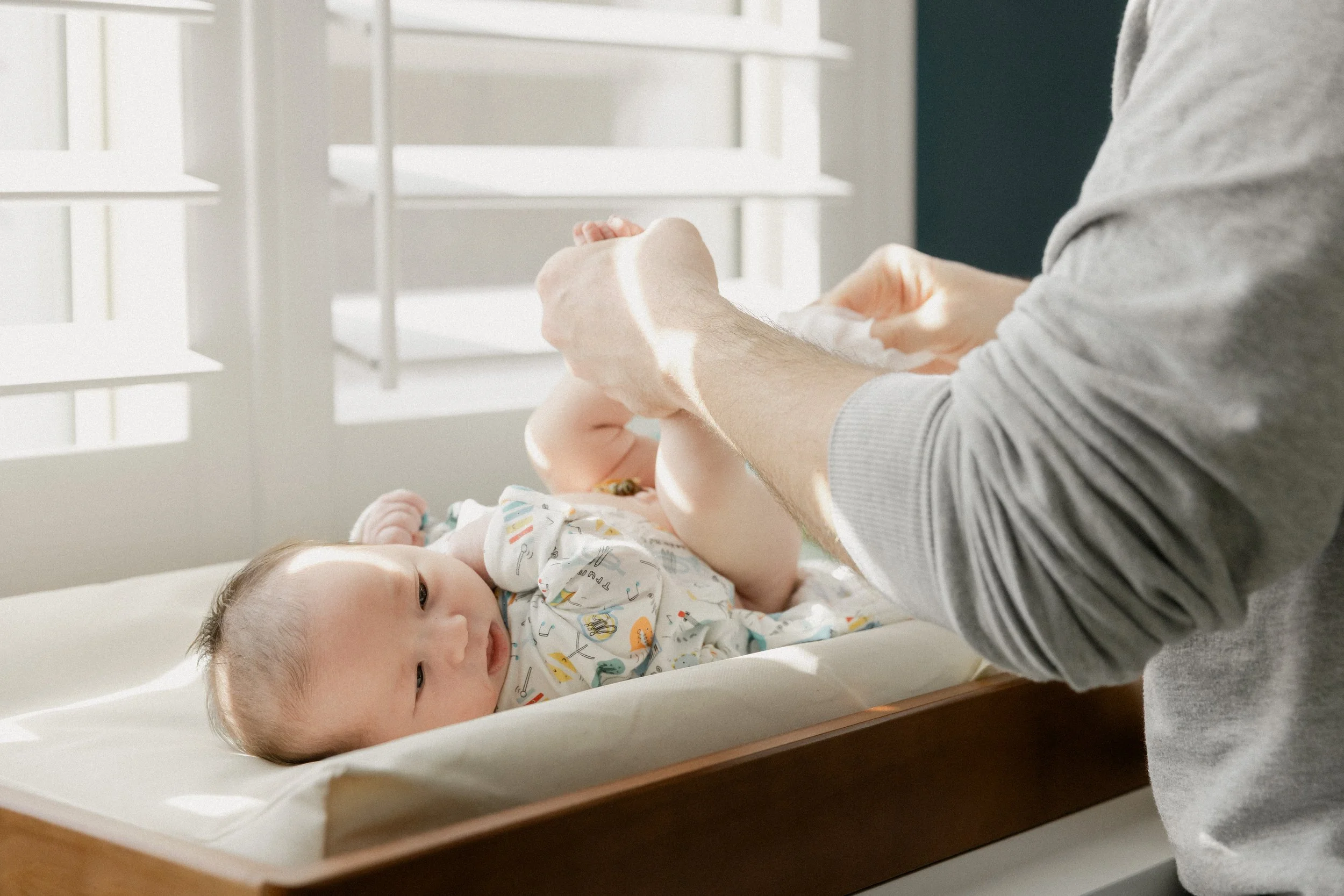 newborn gets diaper changed during in home session in tucson