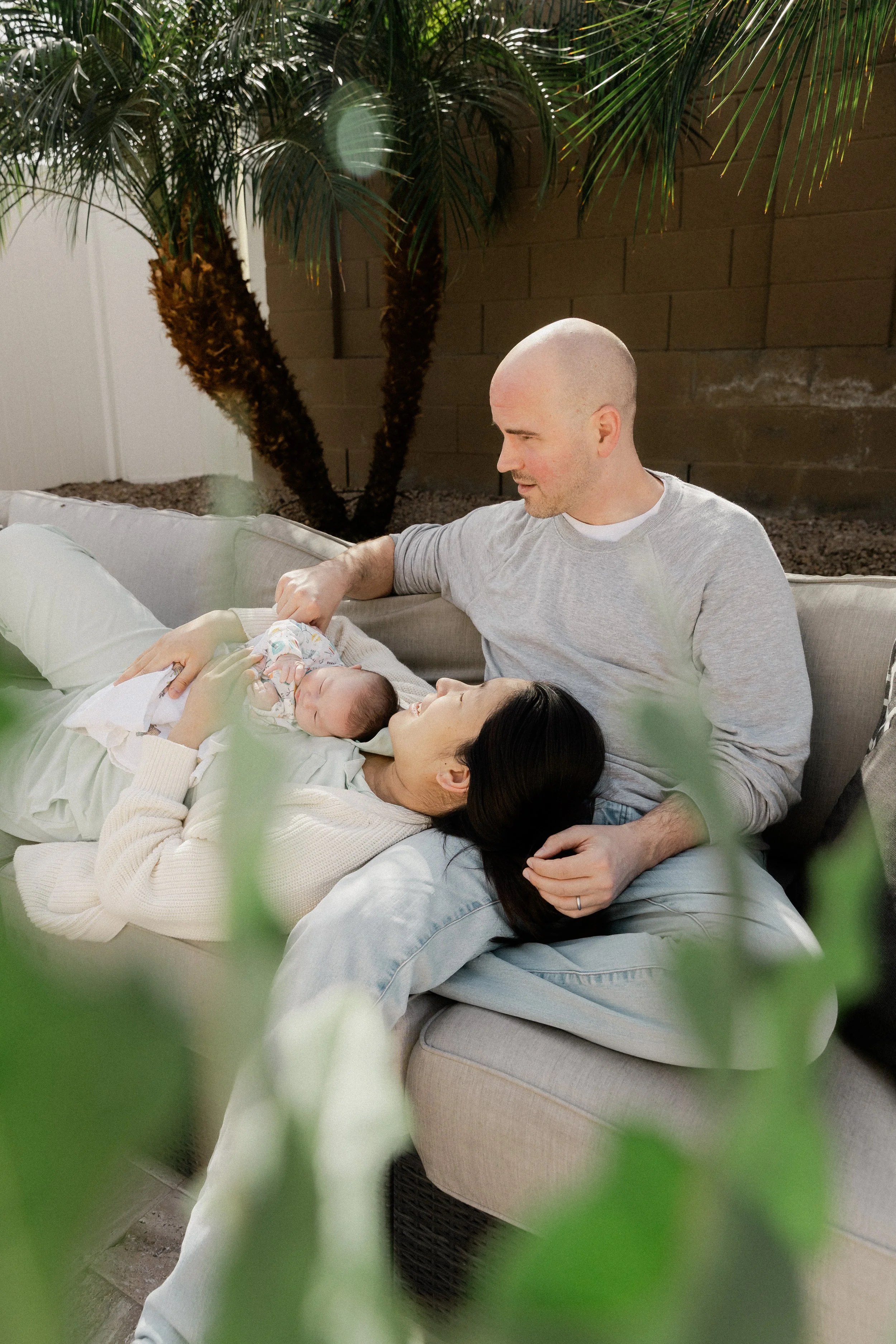 phoenix couple spends time outside with their newborn during a photo session