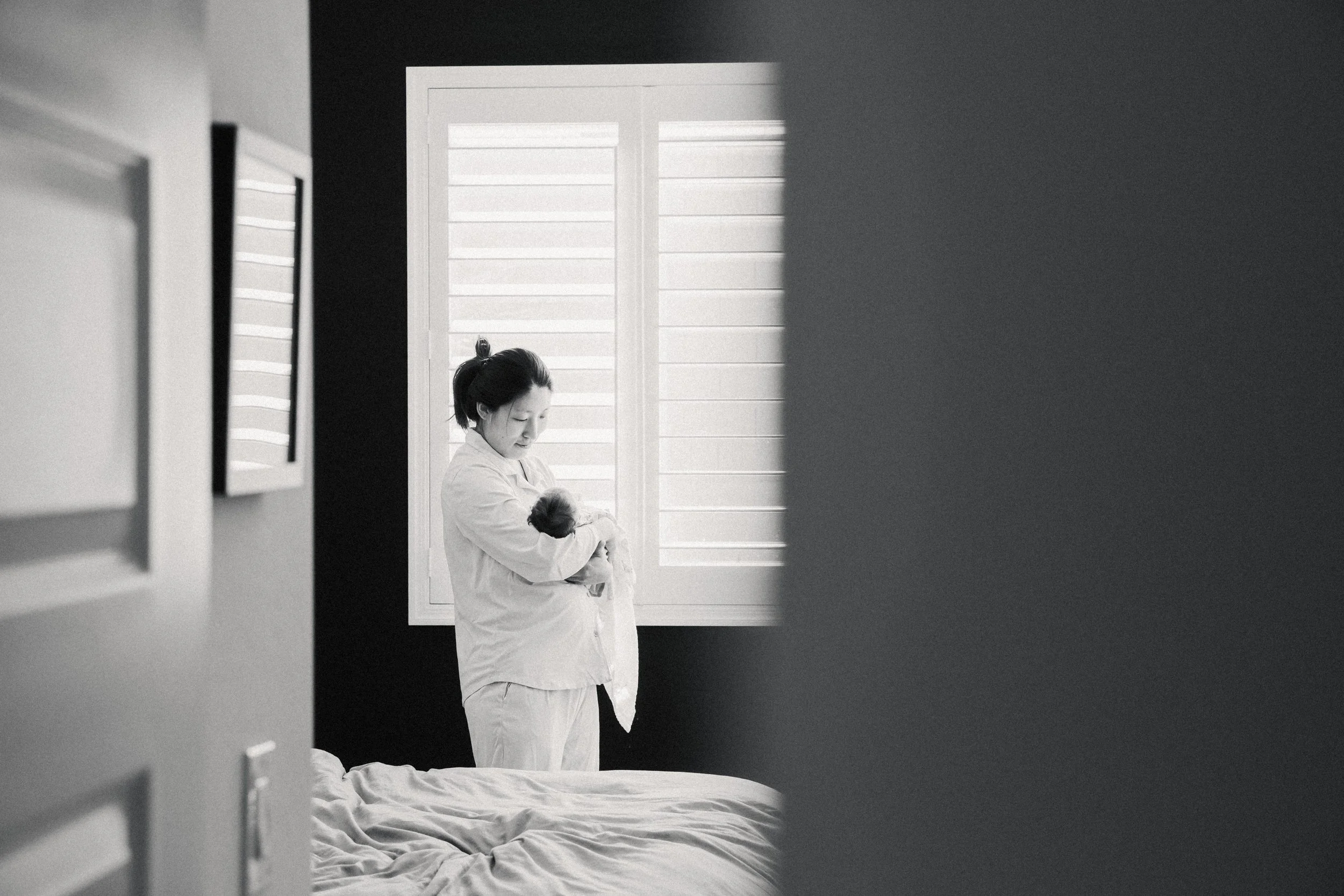 rocking baby to sleep during newborn photos in tucson
