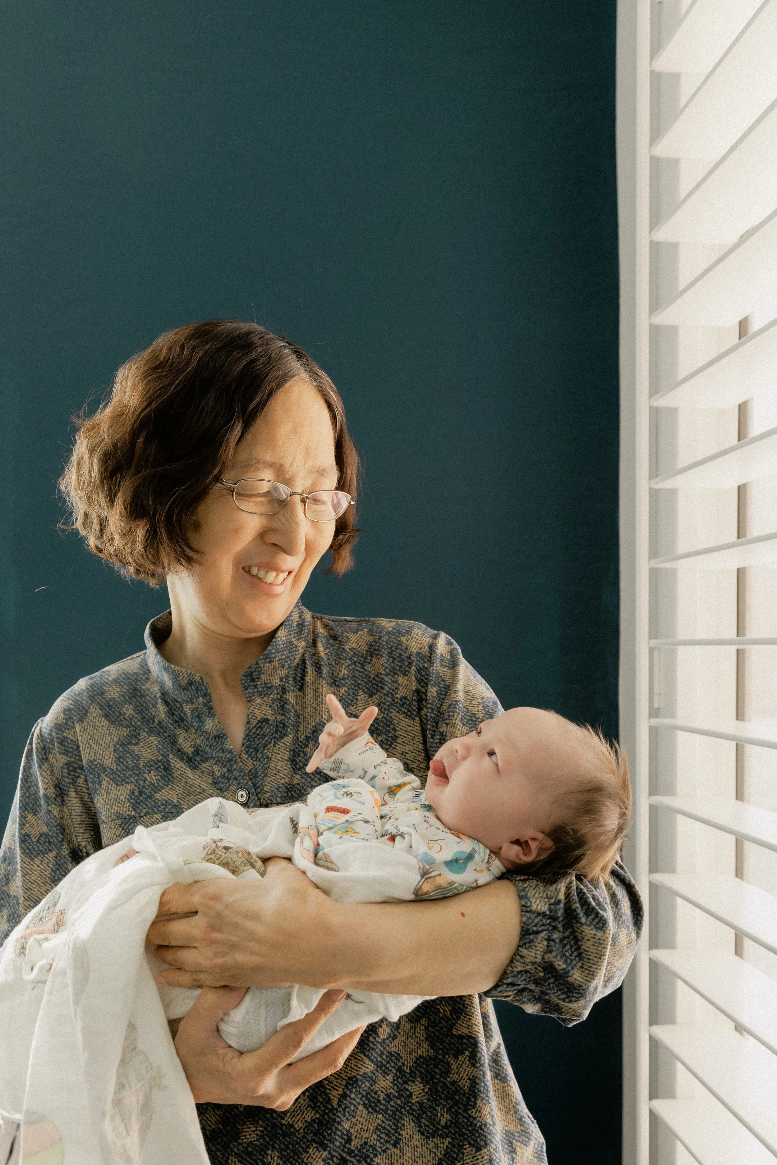 grandma holds baby during an in home newborn session in tucson