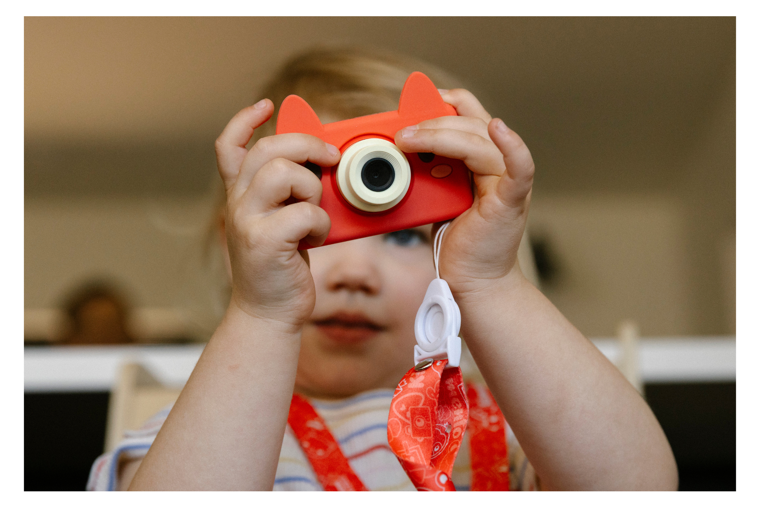 little girl takes a photo with her cat camera during a documentary family photo session in tucson