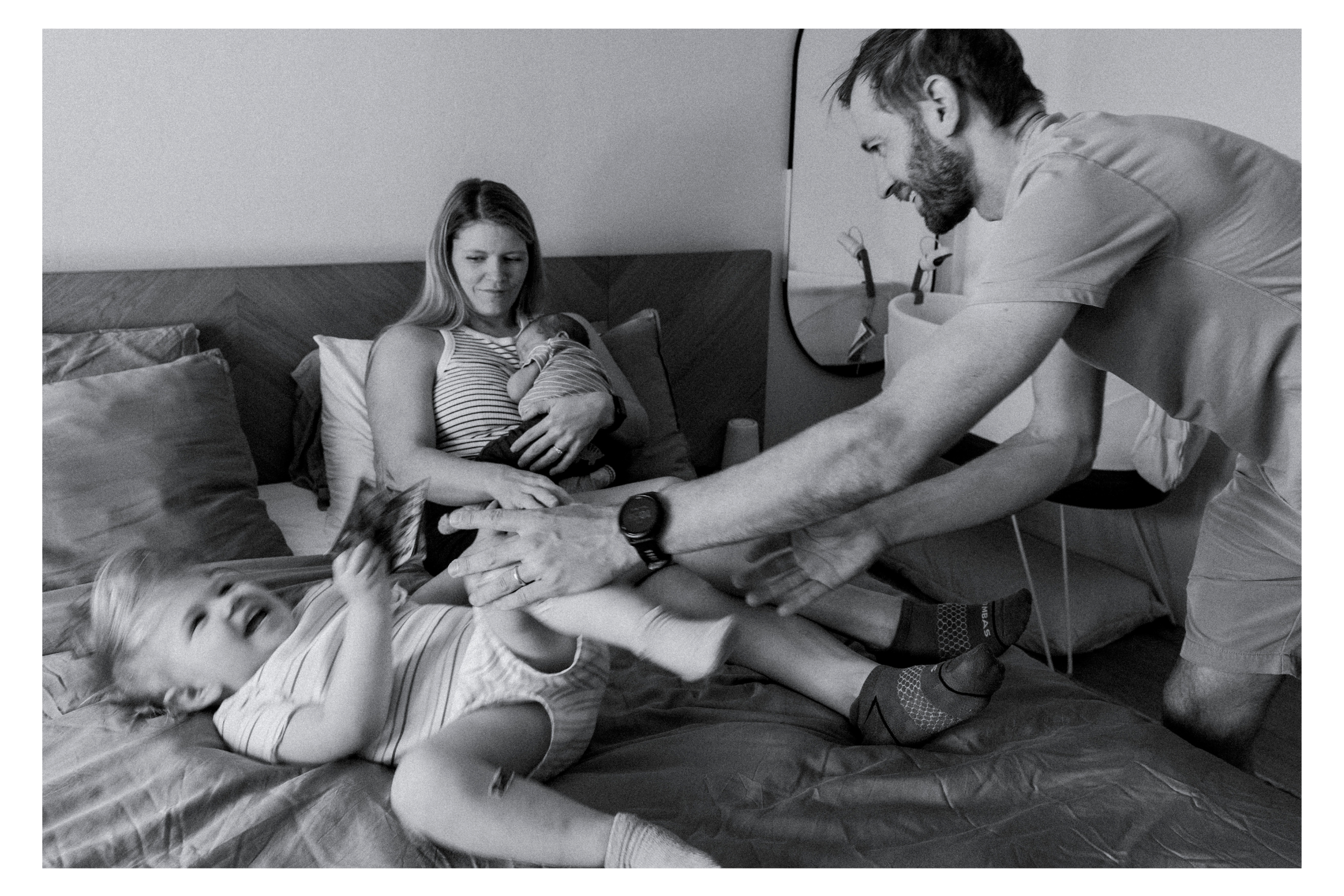 playing on the bed during a newborn session in tucson