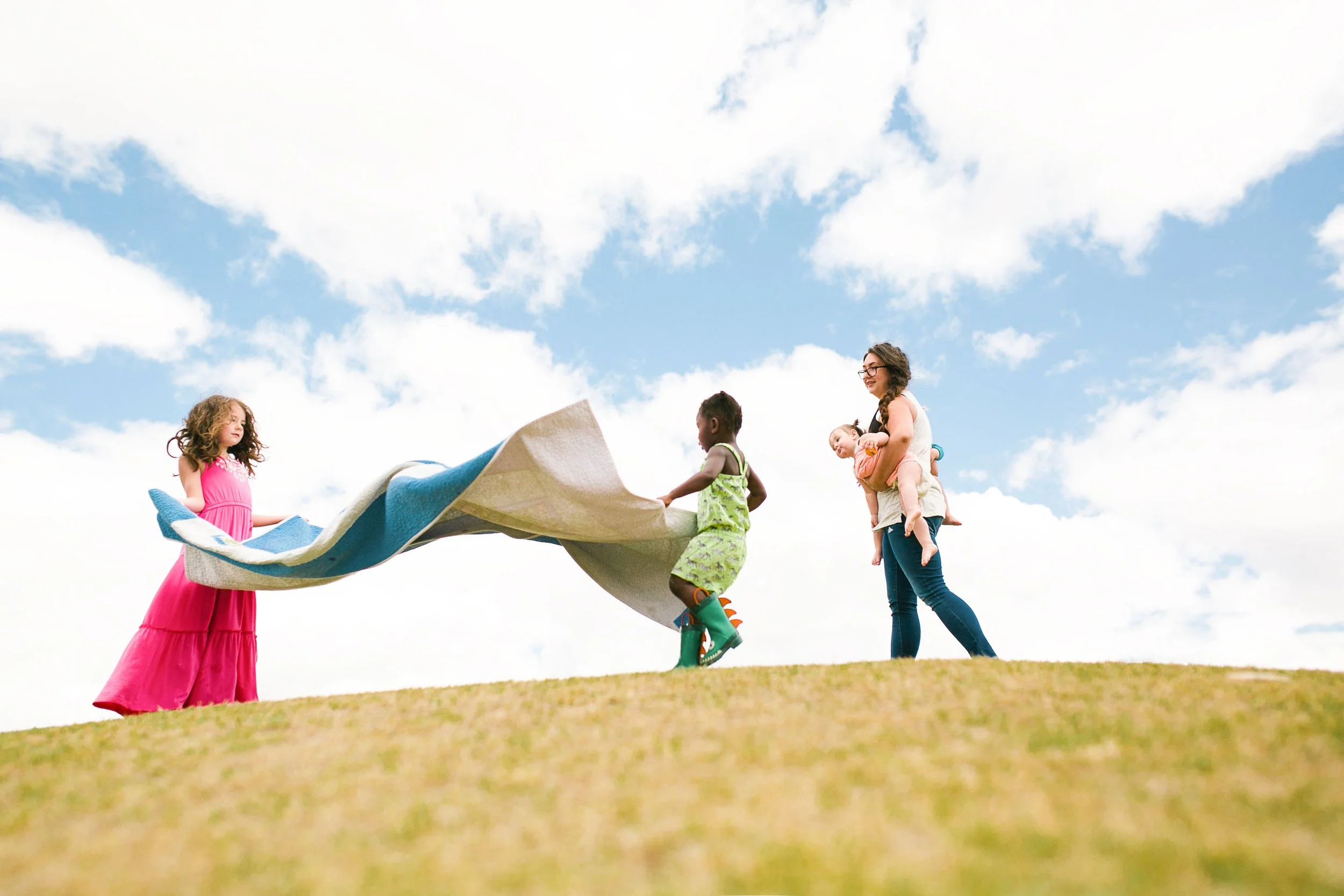 kids place picnic blanket at the park in tucson