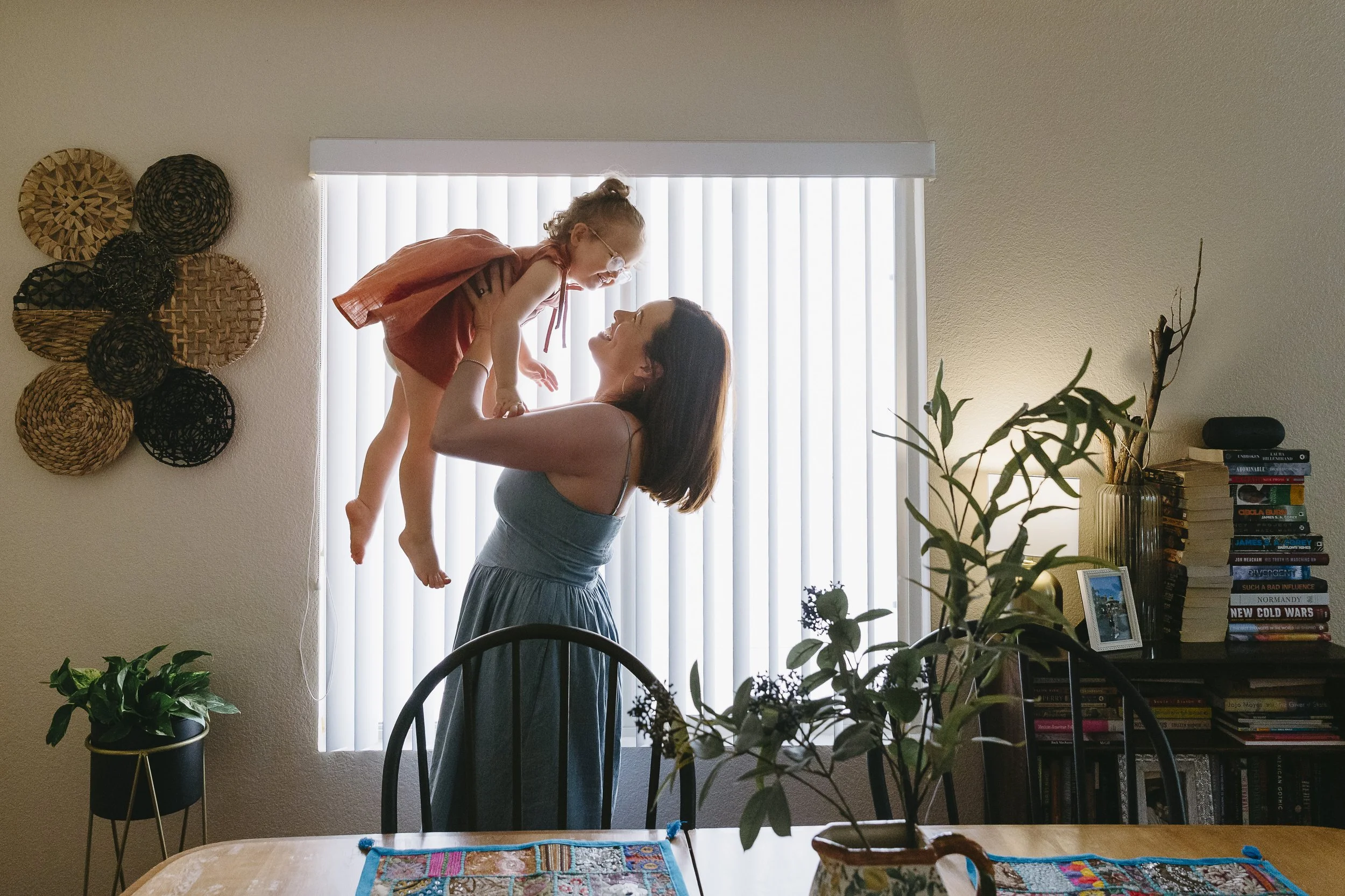 mom lifts daughter at a family photo session in tucson