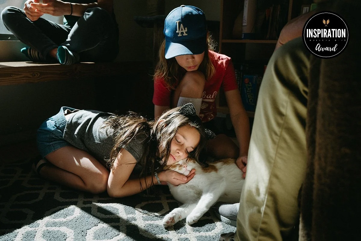 a girl snuggles her cat during a family photo session in Tucson