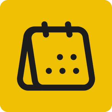 Group of professionals networking and conversing at an indoor event, with warm lighting and modern decor in the background.