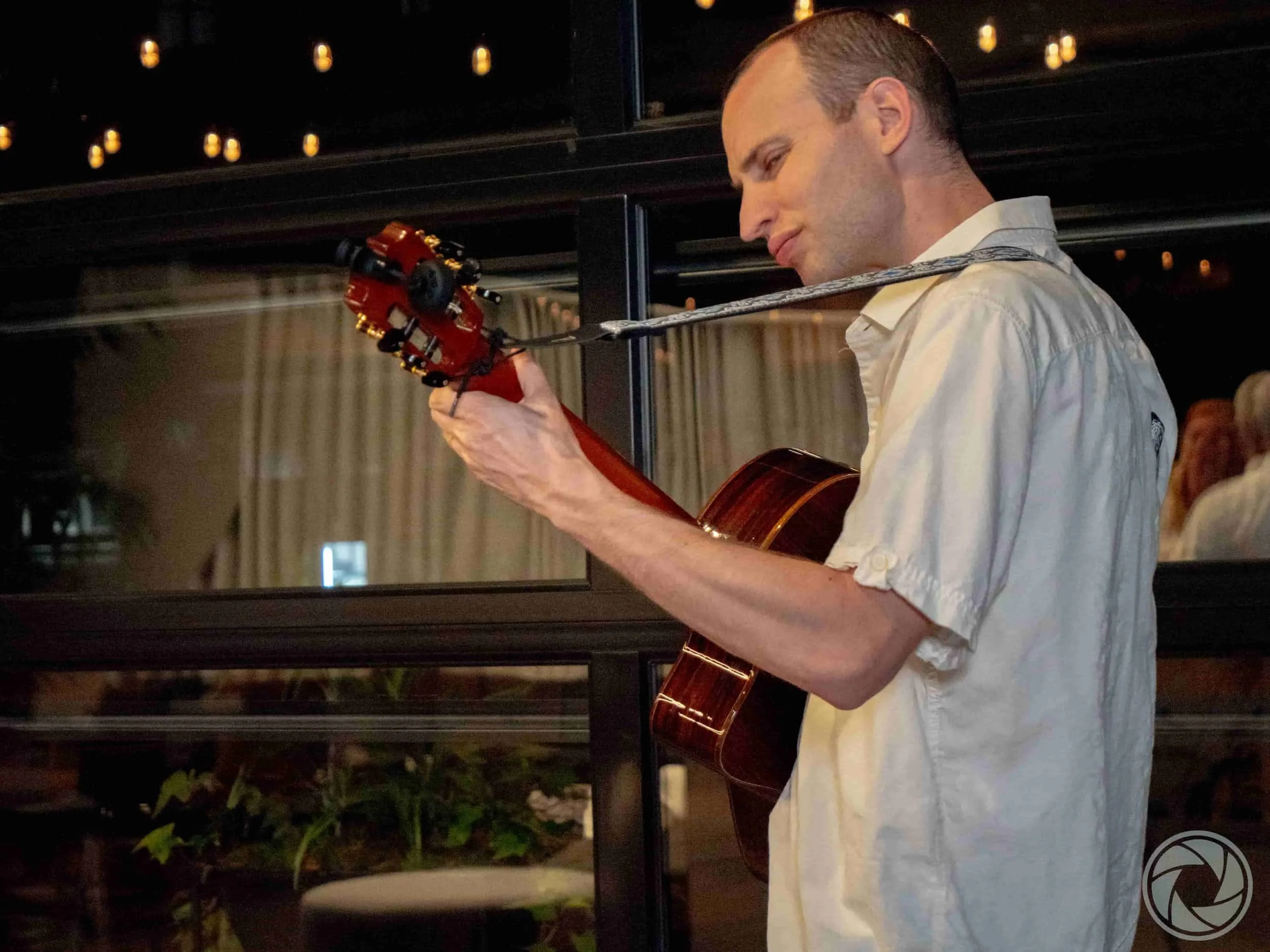 Jim Perona performing guitar at a corporate reception