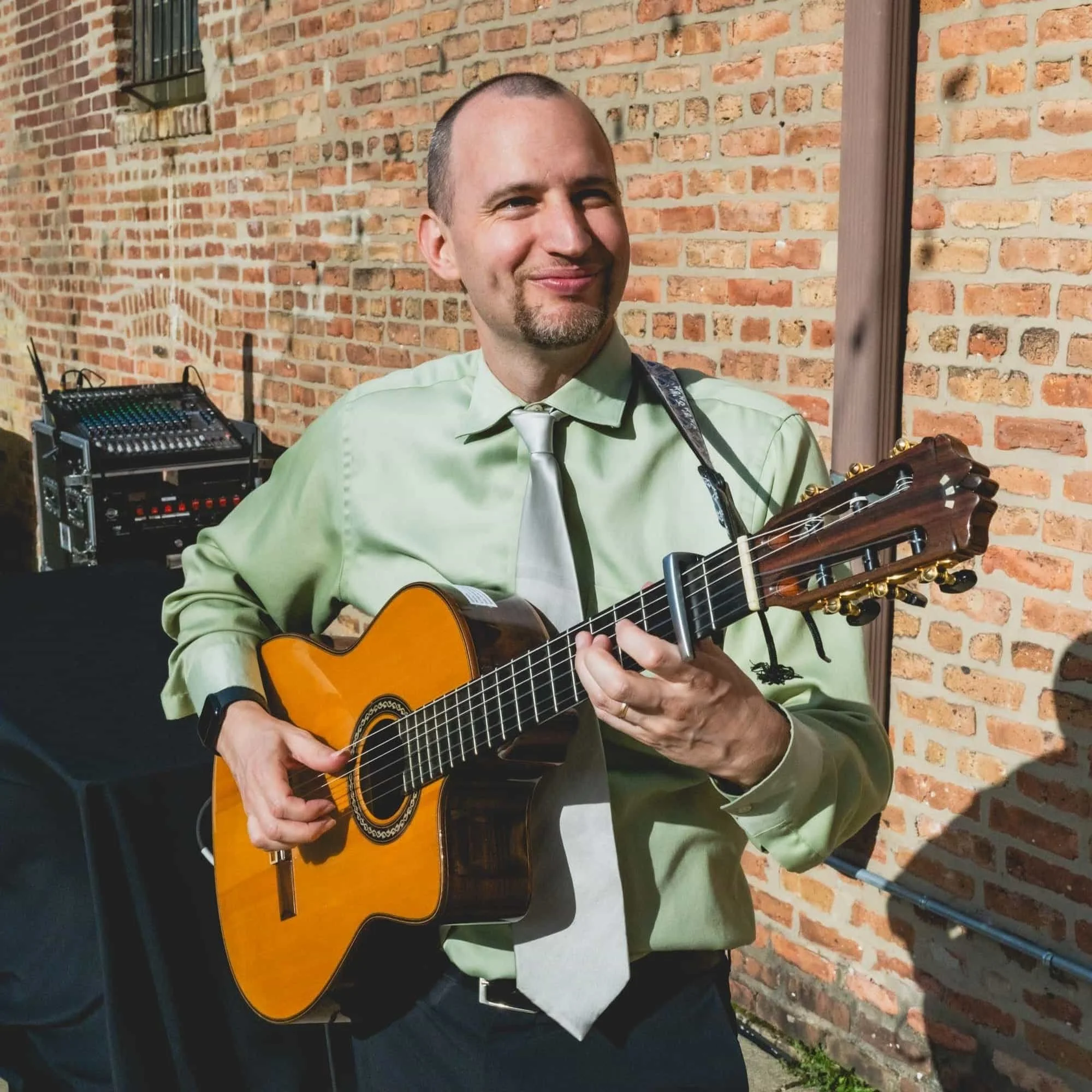 Jim Perona performing live guitar at an outdoor wedding