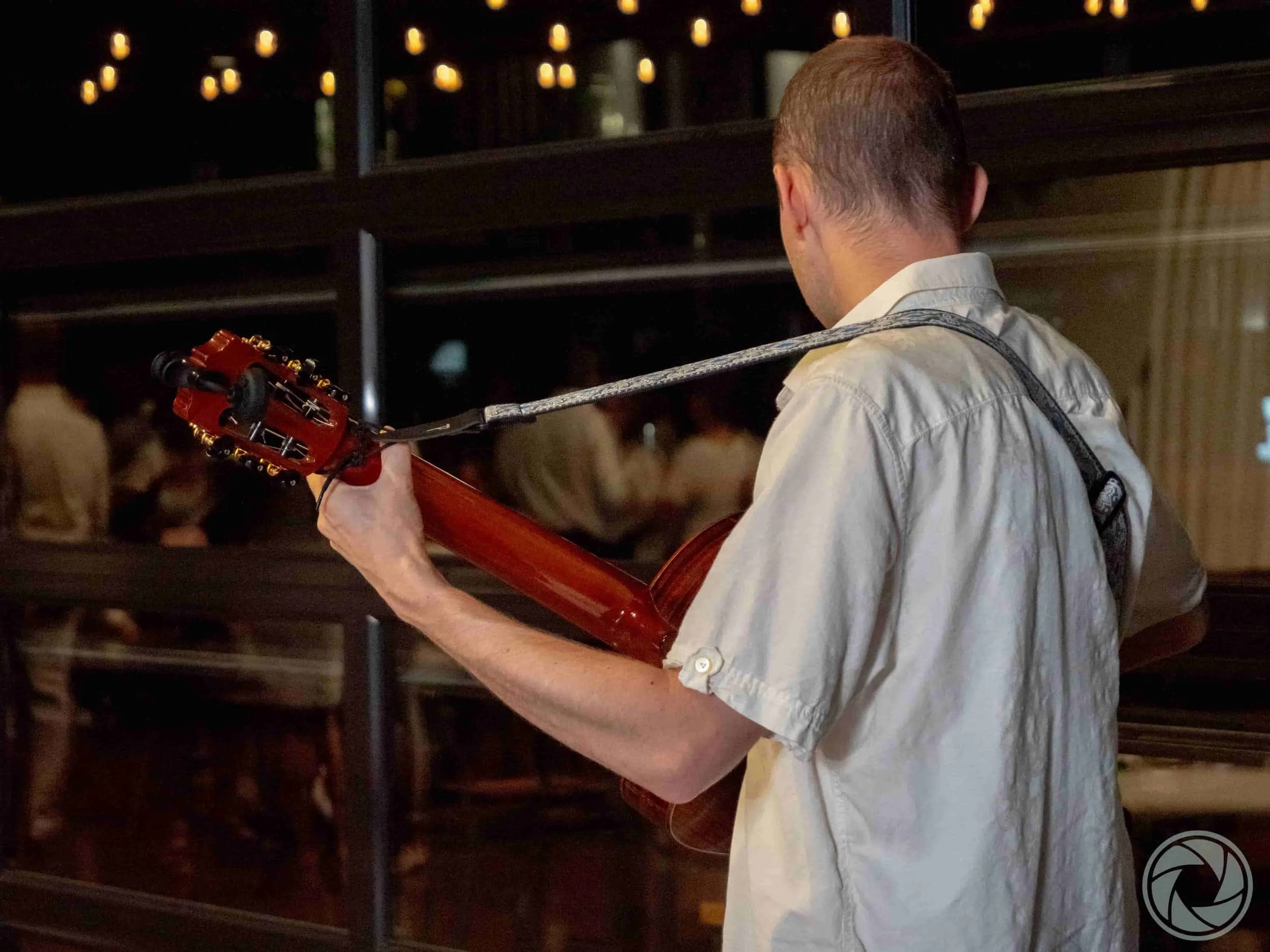 Jim Perona playing guitar at an intimate private gathering