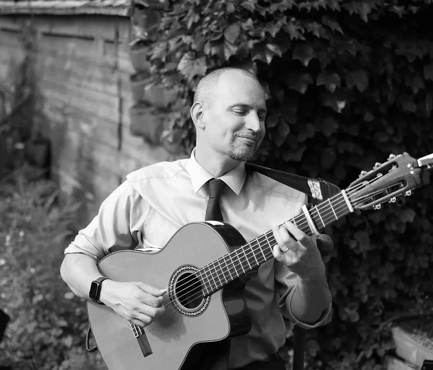 Jim Perona playing classical guitar outdoors in natural light