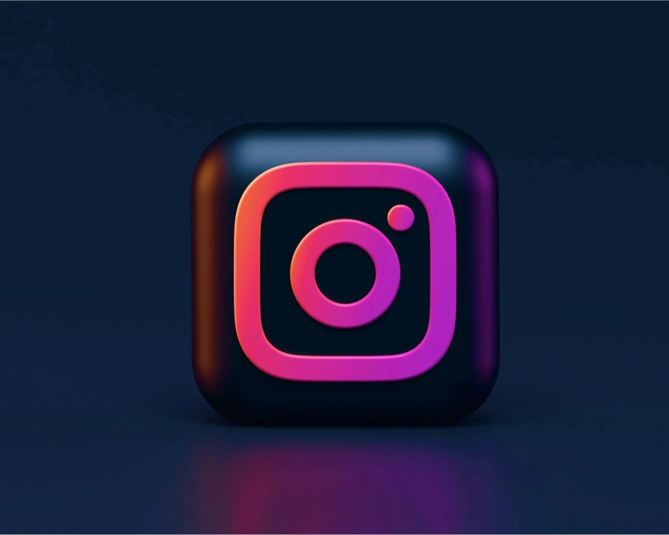 Close-up of a neon-style Instagram logo icon on a dark background, with pink and purple glow effects.