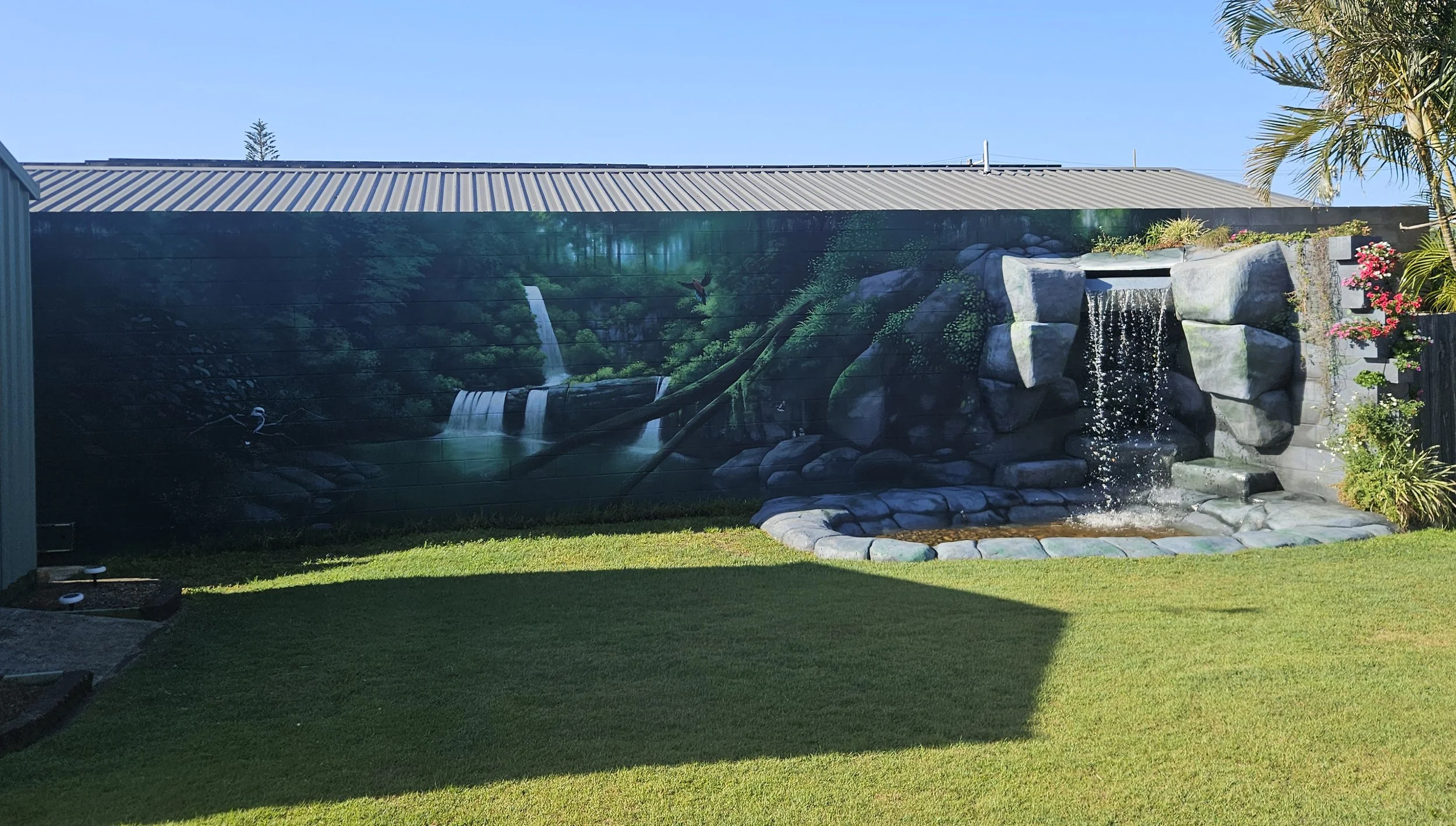 Commissioned Rainforest styled mural painted at a home to the east of Brisbane by the private resident who also one built a fountain into the wall a fountain leading to a wading pool below.
