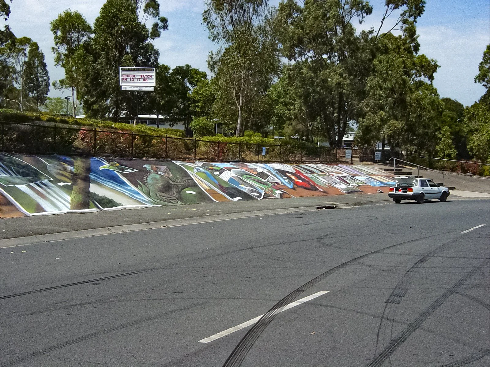 Long mural on retaining wall in front of Shailer Park Primary School 2003