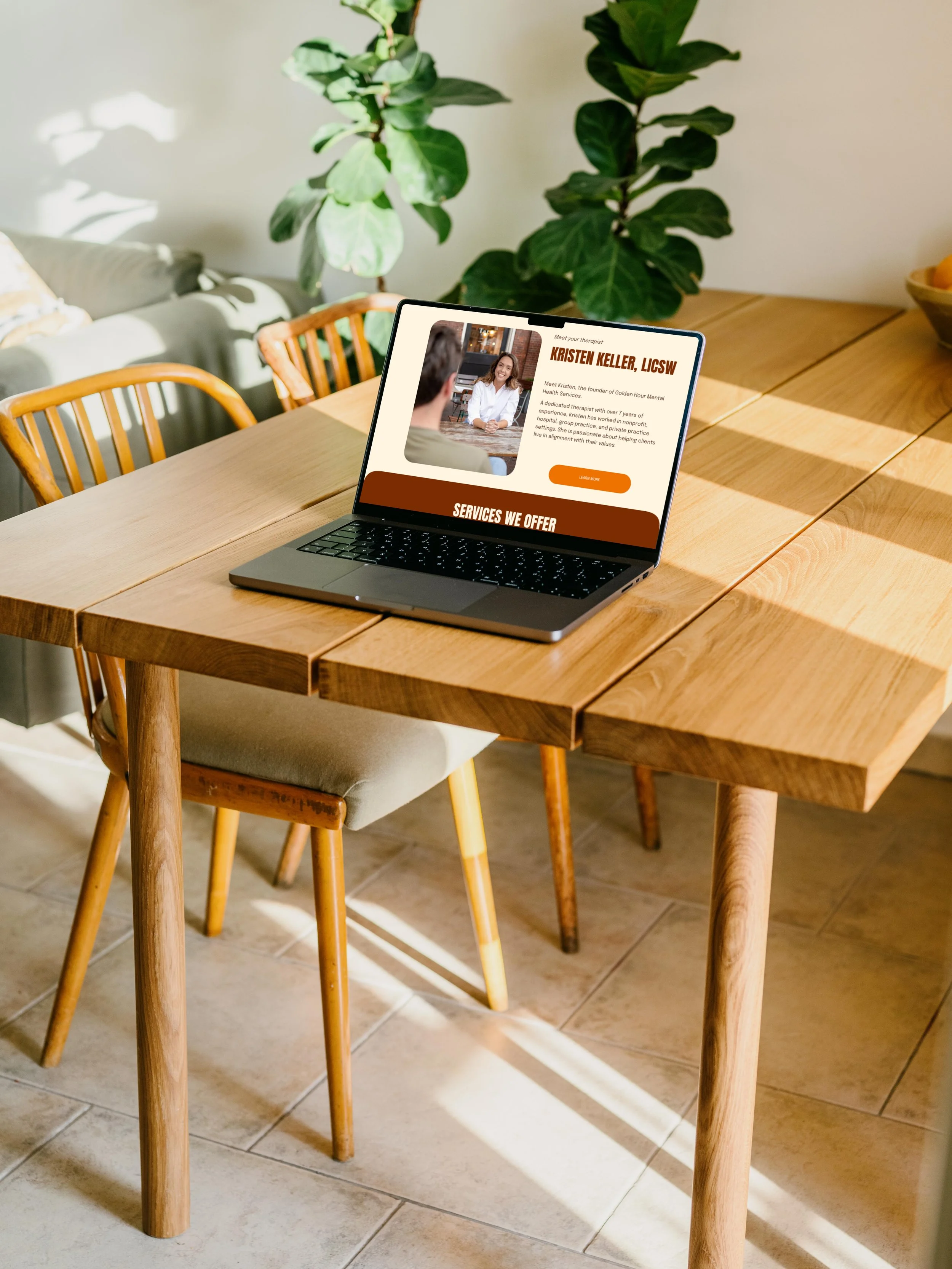 Mockuuups Free MacBook Pro mockup on a table with a plant in the background.jpeg