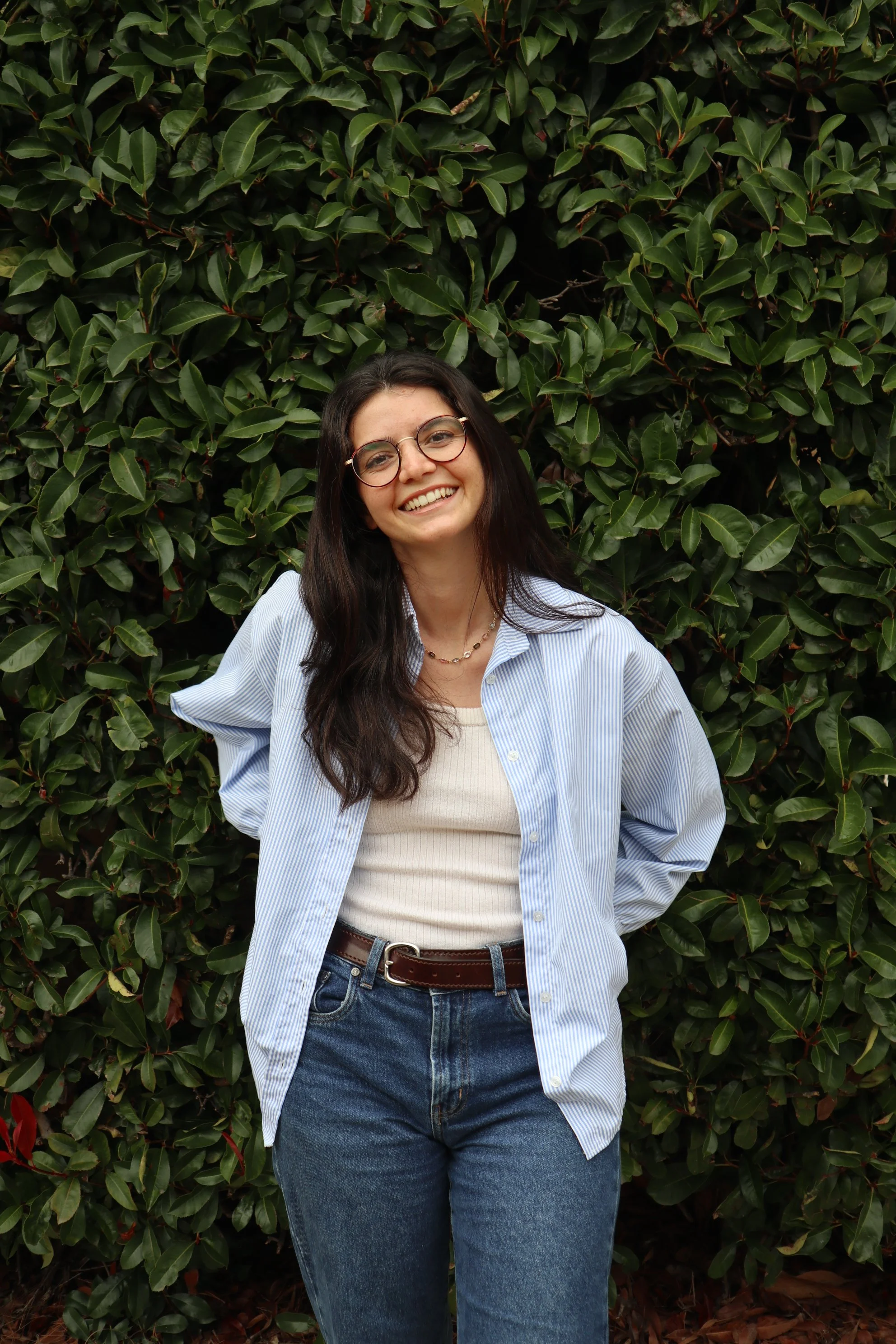 portrait of a woman with glasses, dark hair, and a slight smile