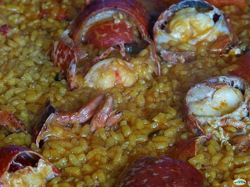 Close-up of seafood paella with lobster, shrimp, and rice