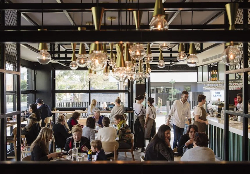 Cafe culture in Highett, Melbourne inside a bustling cafe with industrial light globes hanging from the ceiling