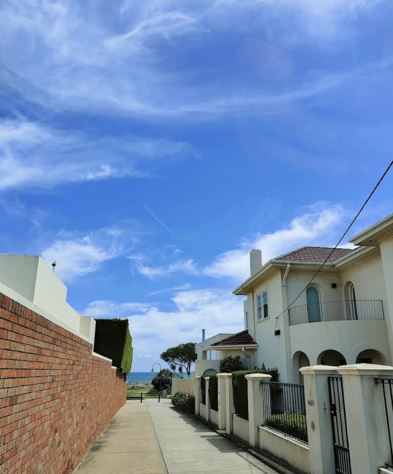 Residential neighborhood street heading down to the beach in Brighton, Melbourne.