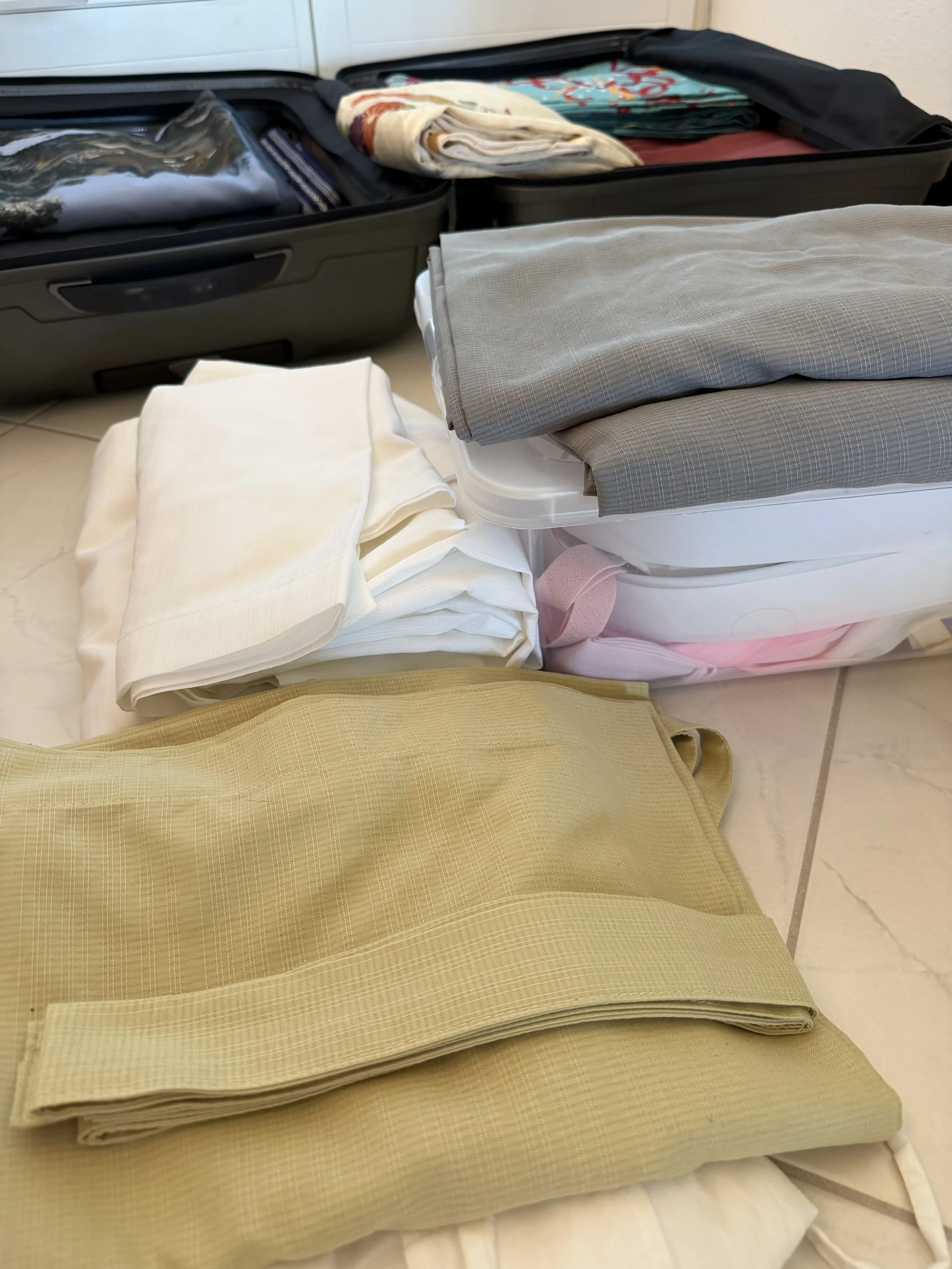 Open suitcases filled with neatly folded kimono articles for an event or a class.