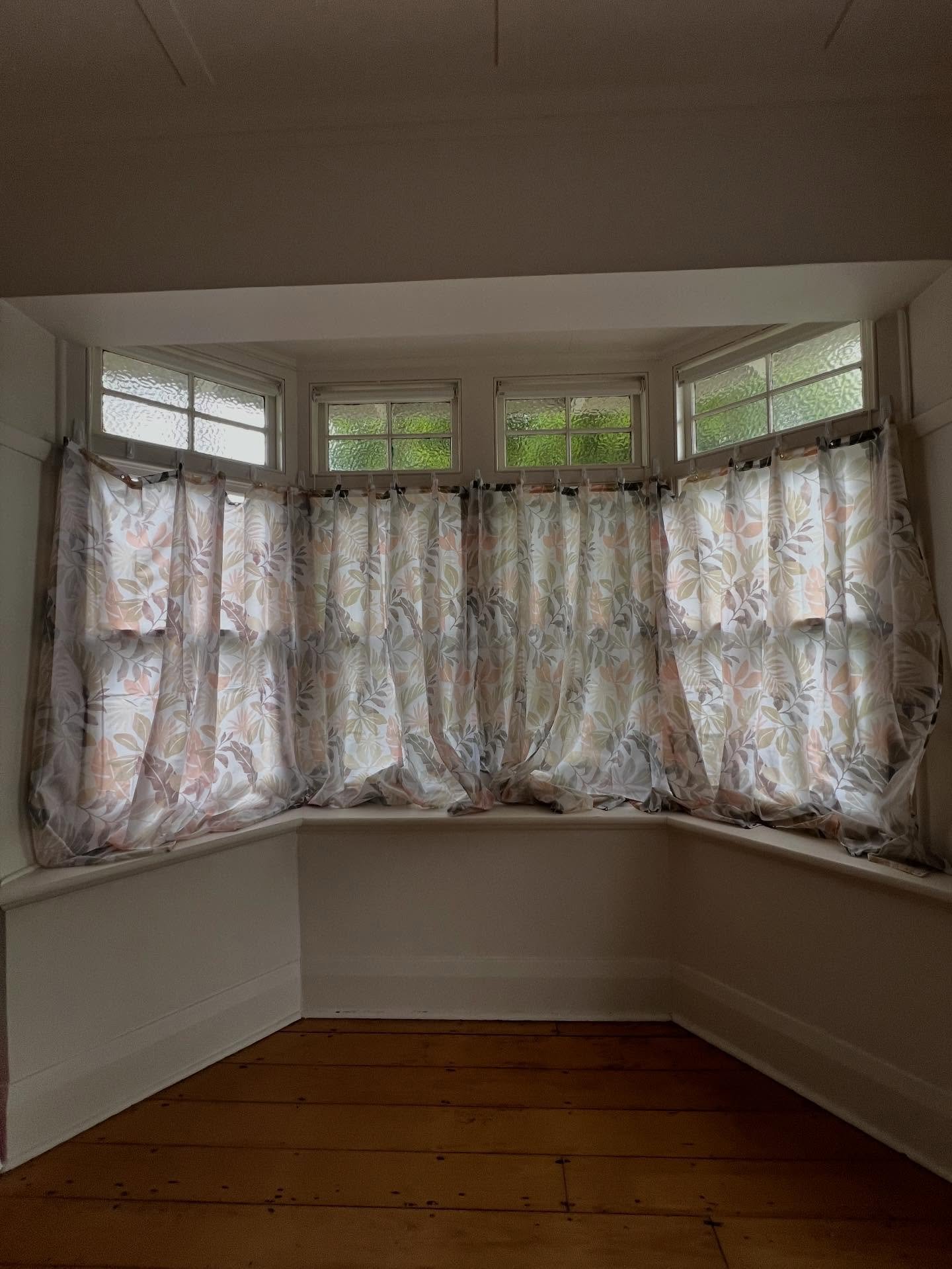 These shower curtains were a fun and necessary tool but the space has been transformed by new window shutters and sheers.