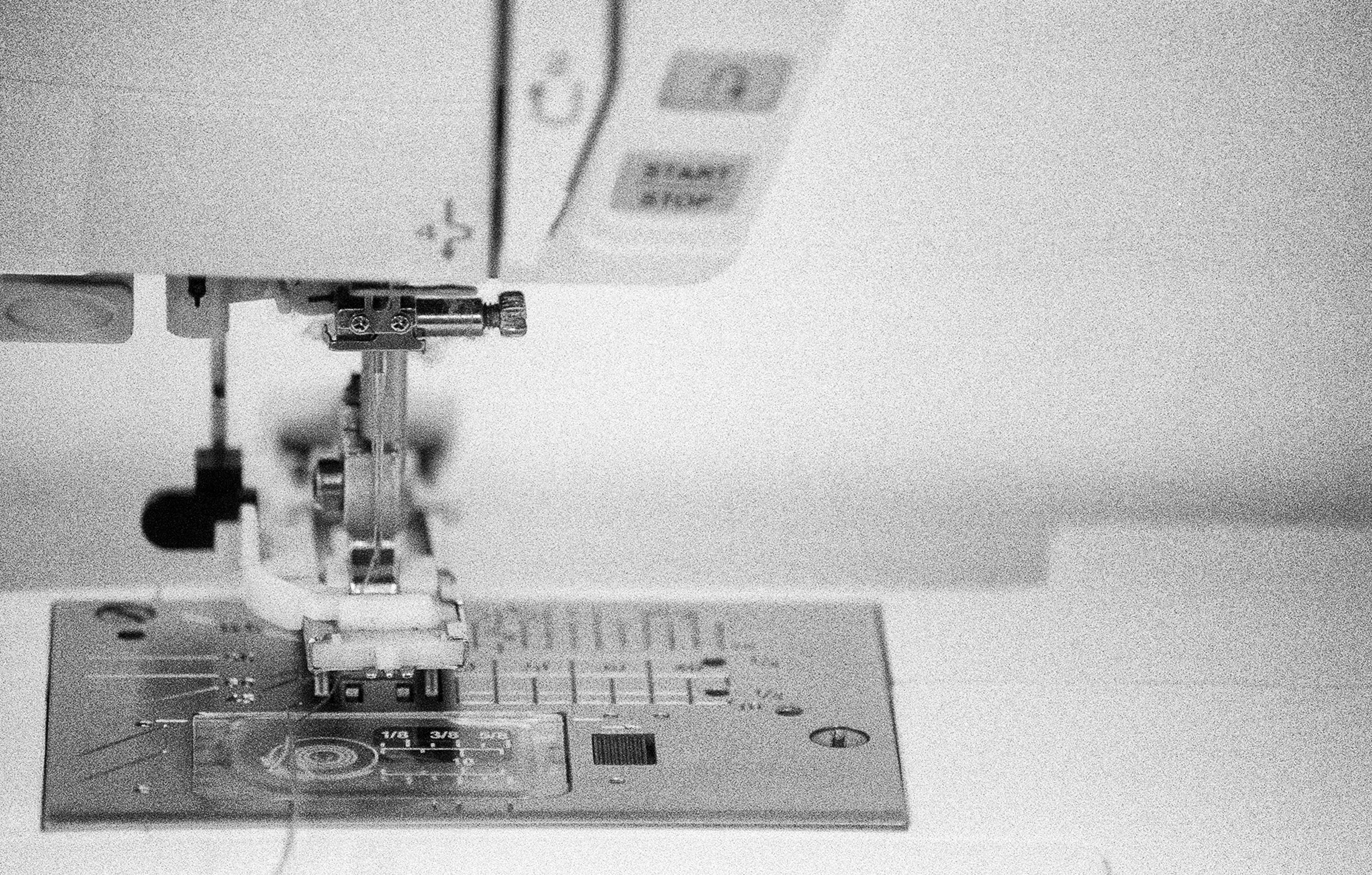 Close up photograph of sewing machine needle mechanism