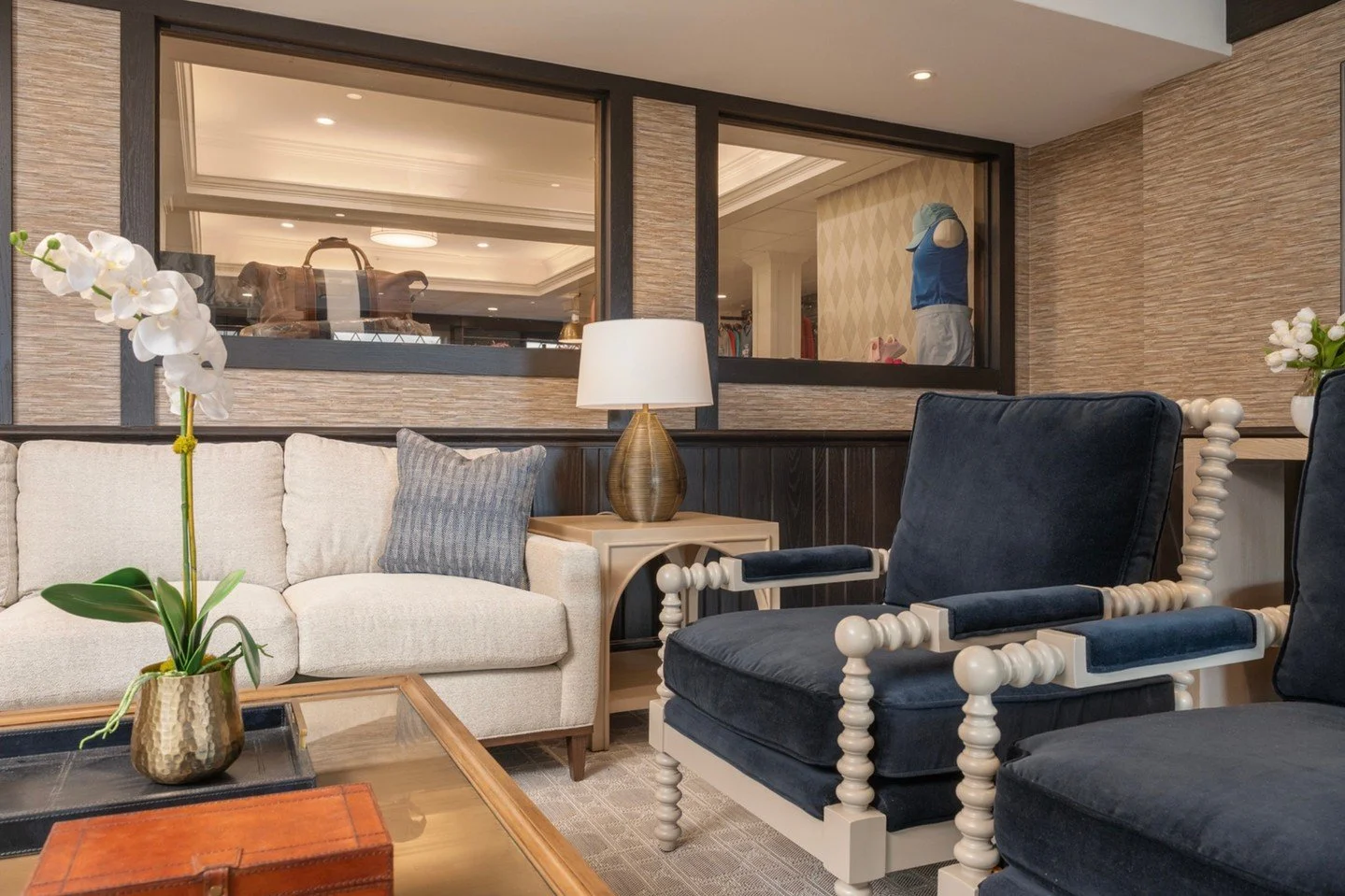 In the Trophy Room lounge at Nassau Country Club, we refreshed the space with new furniture pieces, textural wallpaper, and warm layered finishes &mdash; all thoughtfully coordinated to complement the existing elements. Every selection was designed t