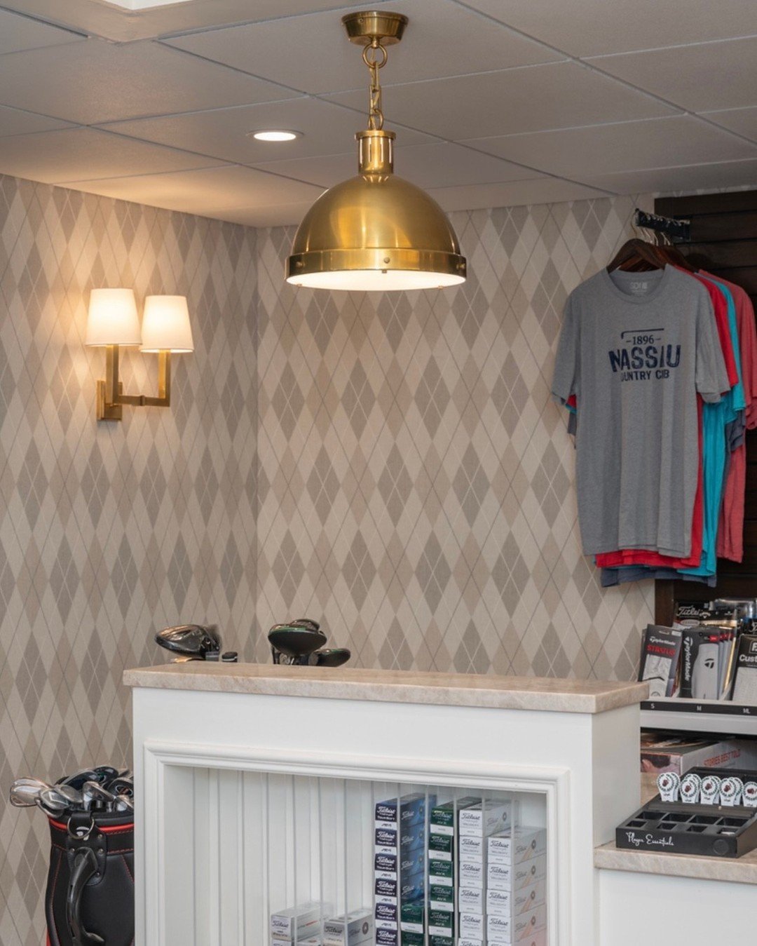 A few of our favorite details inside the newly redesigned Golf Shop at Nassau Country Club &mdash; tailored millwork, fresh merchandising moments, warm brass lighting, and a subtle diamond-patterned wallpaper that adds texture without overpowering th