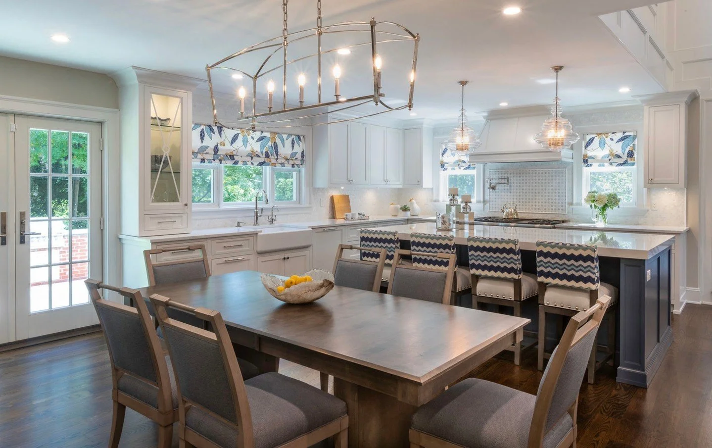 An open floor plan designed for real life&mdash;where the kitchen flows effortlessly into the family room, making everyday moments and entertaining feel easy and connected. Layered blues, warm woods, and thoughtful lighting bring it all together in a