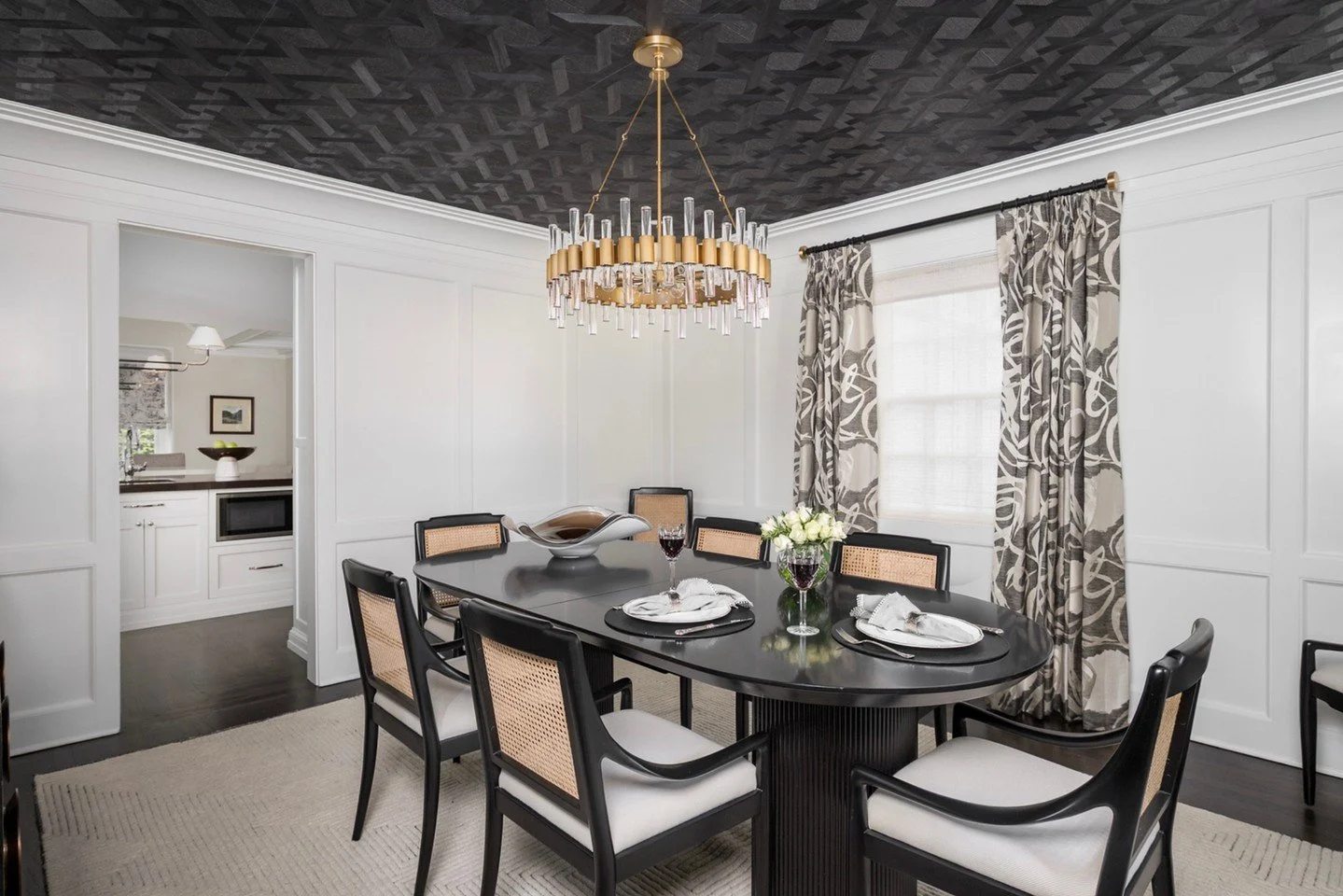 A dining room designed to make a statement&mdash;quietly ✨
In Kerith&rsquo;s home, crisp white paneling sets a classic foundation while the real wood wallpaper on the ceiling adds warmth, depth, and unexpected texture. Finished with rattan chairs and