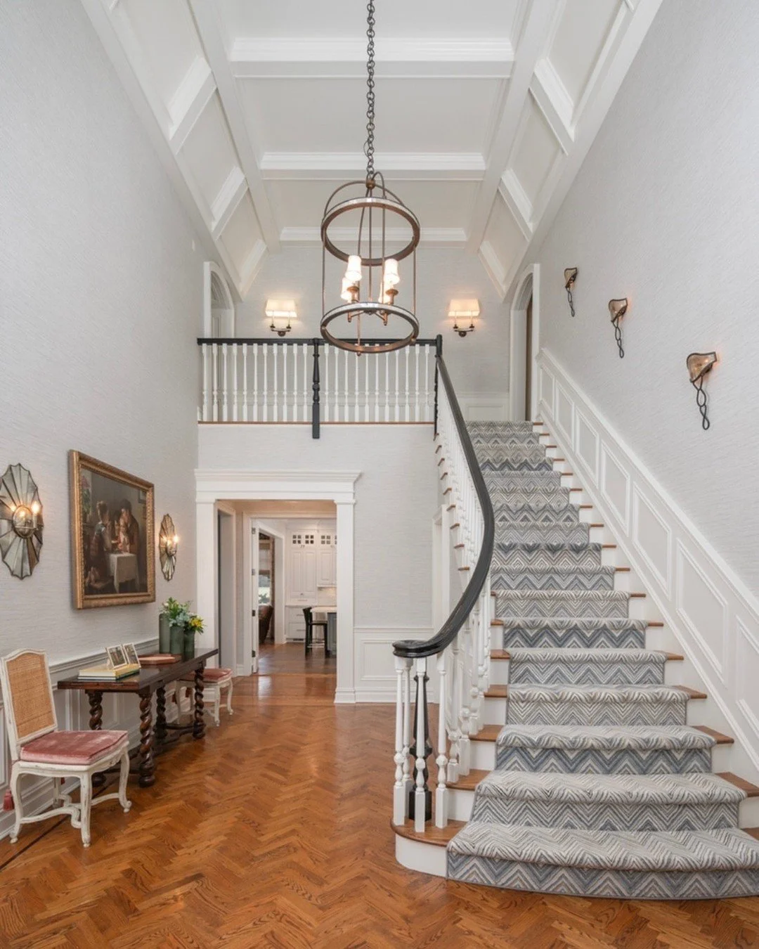 Walk through our newest project with us 🤍
The richness of these stunning wood floors sets the tone from the moment you walk in, while a Missoni runner adds movement and pattern up the staircase. Layered with subtle texture through the wallpaper, thi