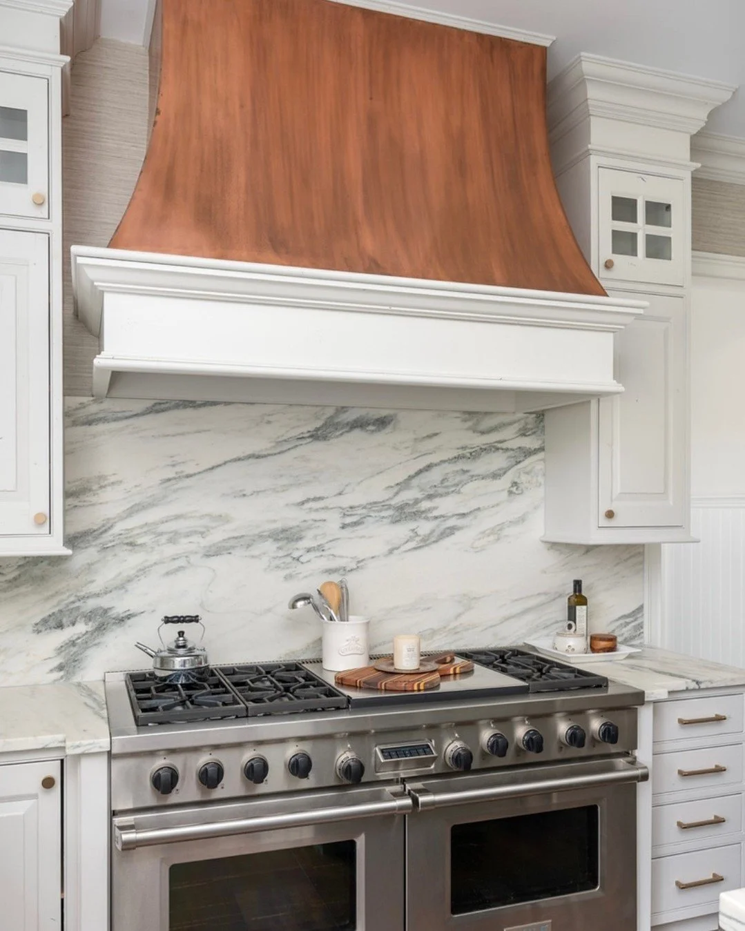 A well-designed hood can completely transform a kitchen ✨
This became our focal point&mdash;keeping the existing copper hood for warmth and character, while painting the lower portion to add contrast and detail. We carried the countertop material up 