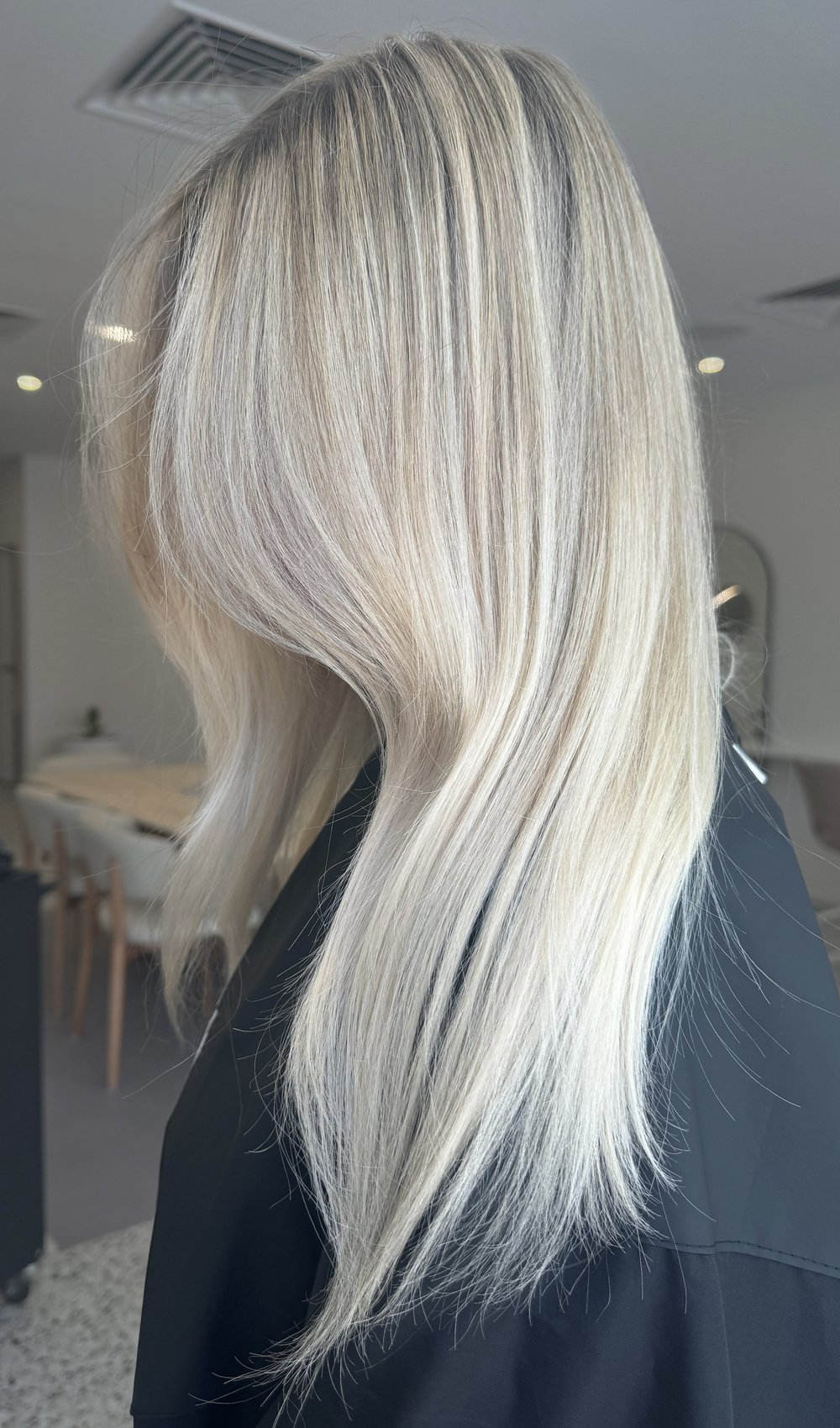 Layered blonde hair created at Studio REMMI