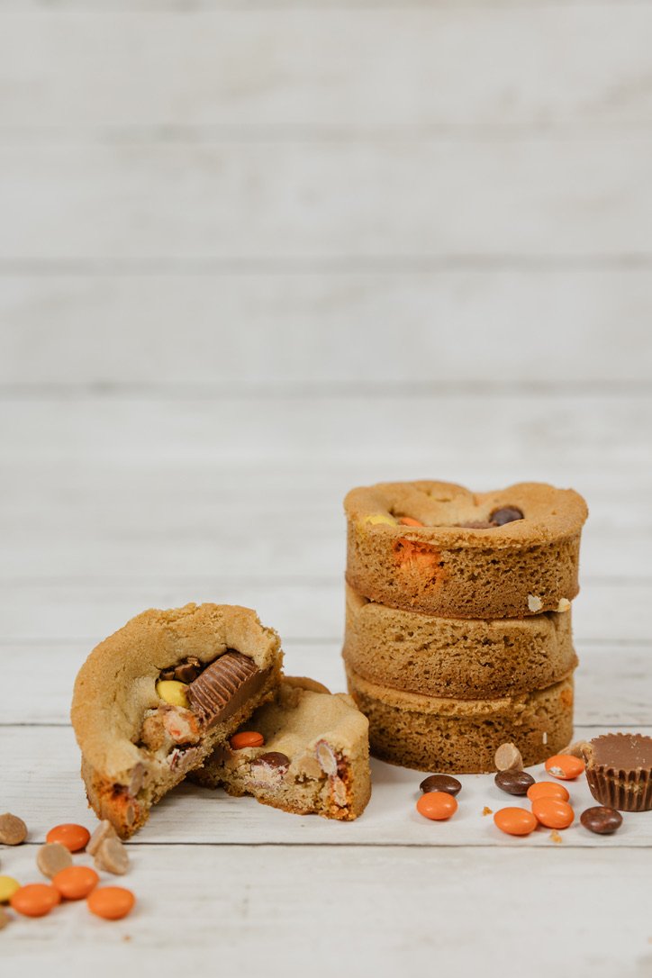 Reese - Soft peanut butter cookie dough filled with peanut butter chips & Reese Pieces, topped with more Pieces and Reese peanut butter cups