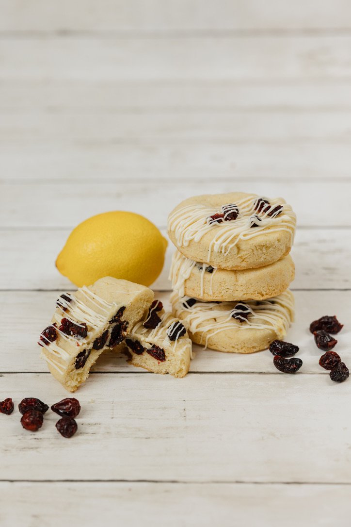 Lemon Cranberry - soft sugar cookie loaded with lemon zest & studded with Craisins, topped with more Craisins and a drizzle of white chocolate.