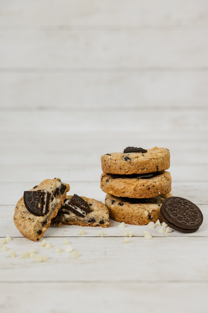 Cookies & Cream - Buttery, brown sugar cookie dough filled with oreo cookie chunks and white chocolate chips, topped with half an oreo cookie.