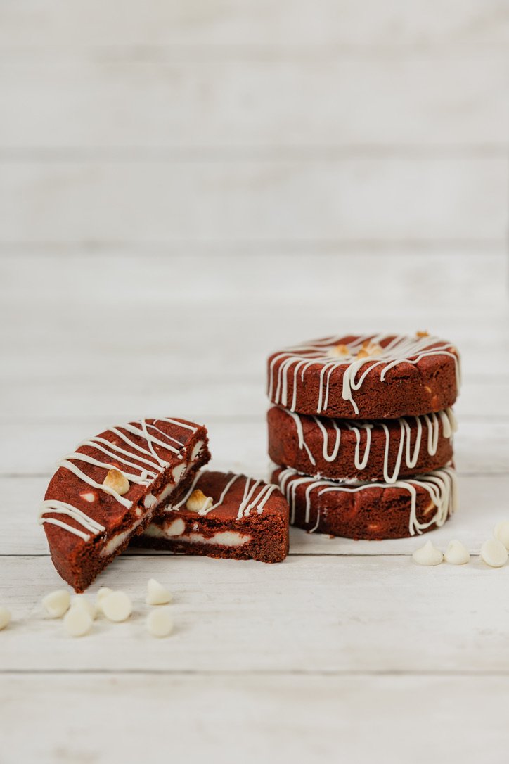 Red Velvet - Buttery, brown sugar cookie dough transformed into red velvet, dotted with cream cheese chips, and stuffed with a cream cheese filling.