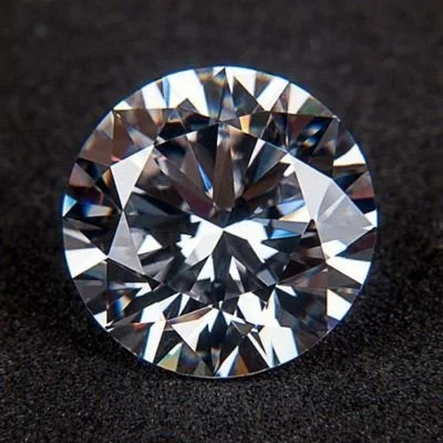 Close-up of a round-cut diamond on a black background.
