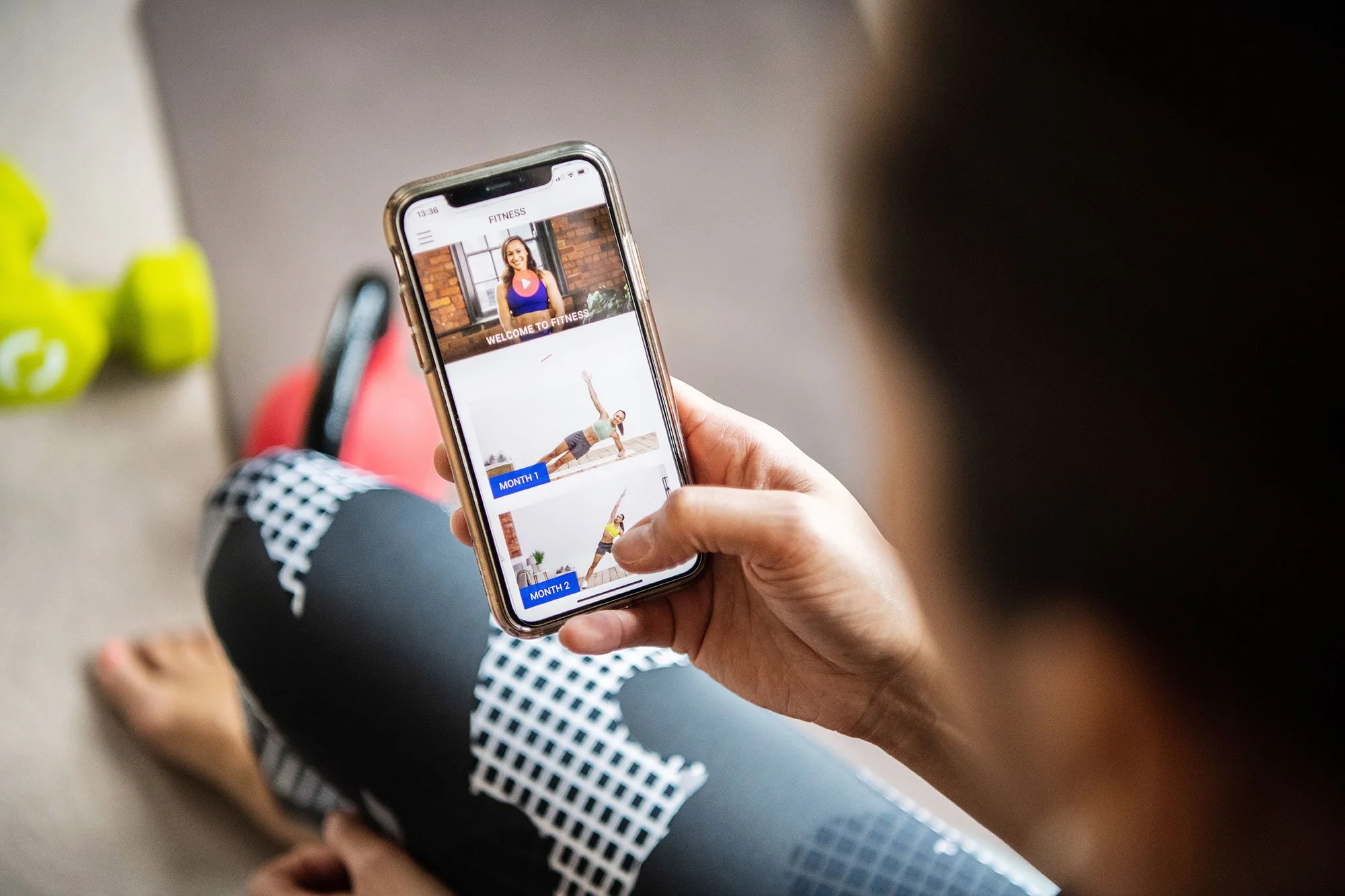 Jessica Ennis Hill hand holding phone with Fitness App