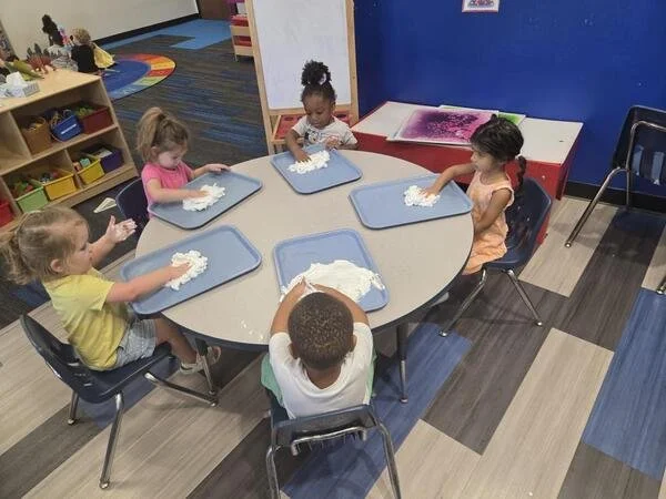 Kids creating a messy craft together