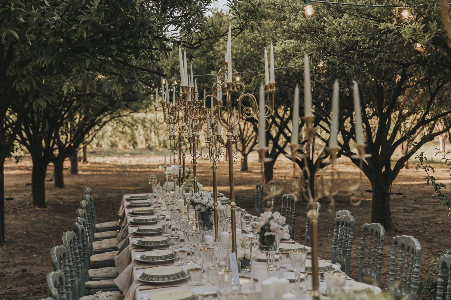 An elegant outdoor wedding reception in a Sicilian citrus grove planned by native Italian planner Lalla Crippa