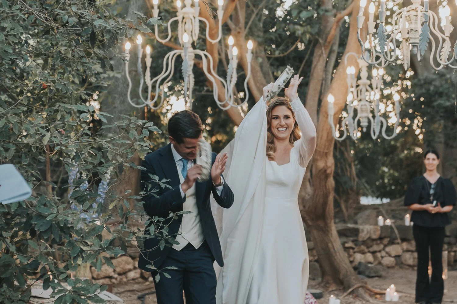 A luxury outdoor wedding ceremony in Sicily under chandeliers in the trees planned by Lalla Crippa