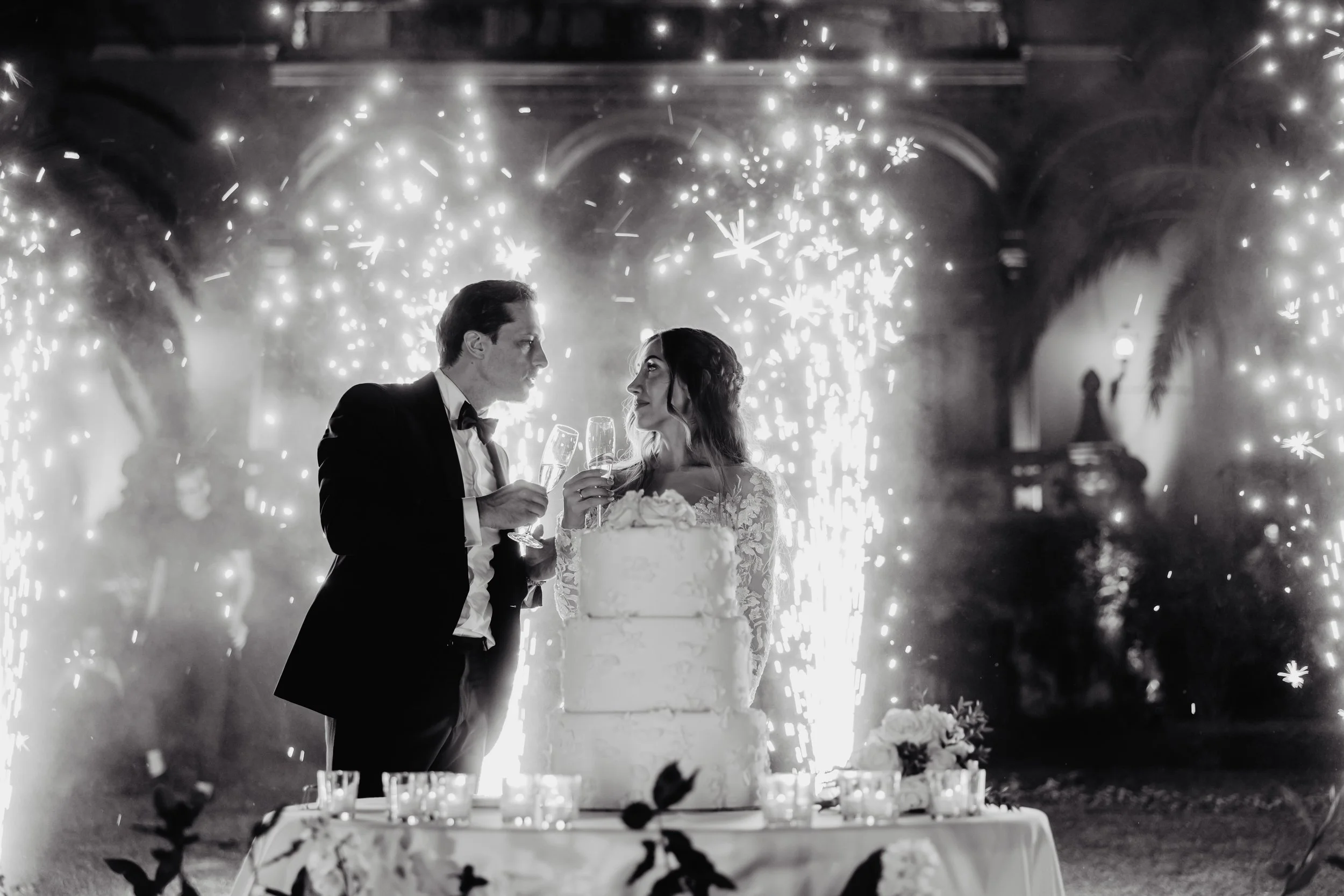 A dramatic wedding cake cutting moment with fireworks at a Lake Como wedding planned by Lalla Crippa