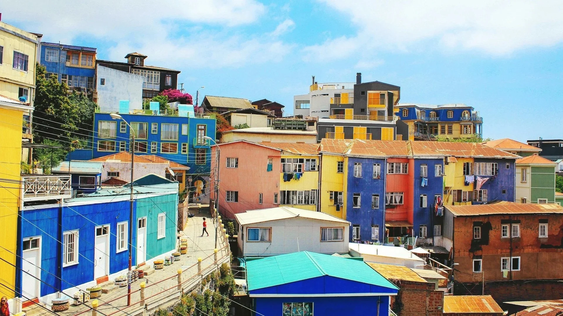 A dense hillside of brightly painted, multi-colored houses and winding streets in Valparaíso.