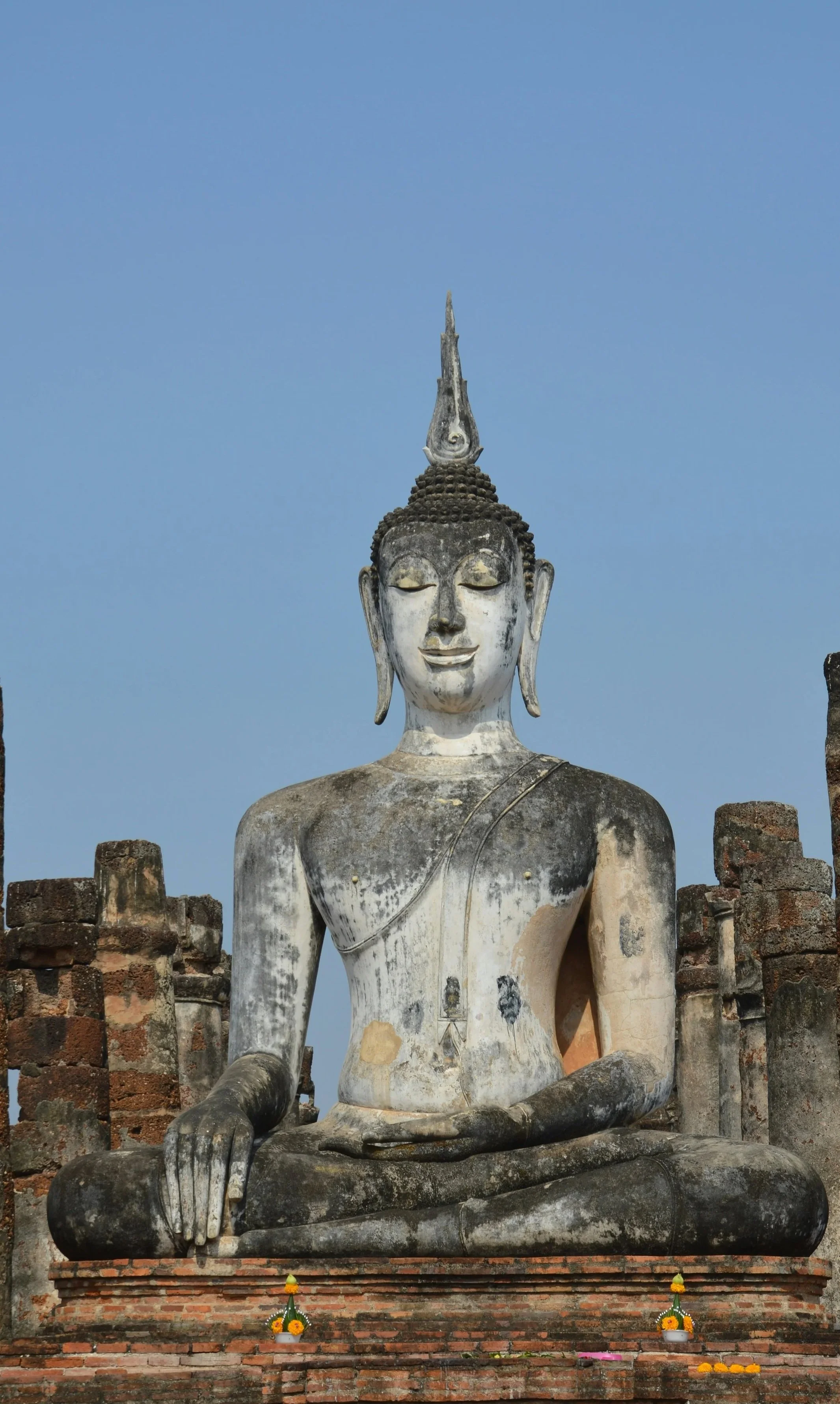 Large ancient seated **Buddha statue** at a temple in Thailand.