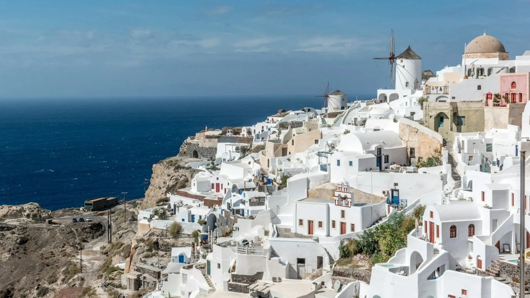 Whitewashed cliffside village of Oia, Santorini, Greece, overlooking the deep blue Aegean Sea.