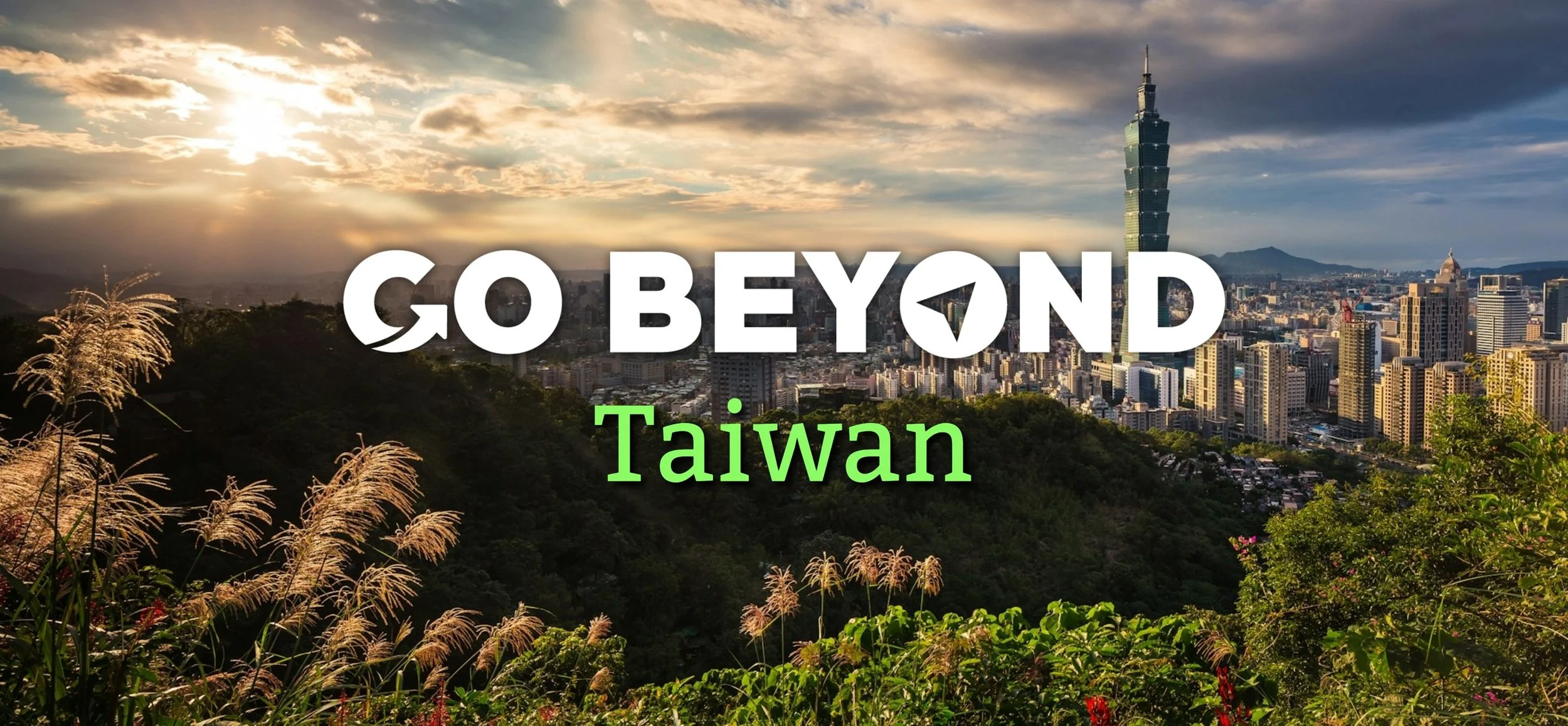 A scenic overlook of the Taipei city skyline at sunset with the text "GO BEYOND Taiwan" overlaid across the center, framed by tall grass in the foreground.
