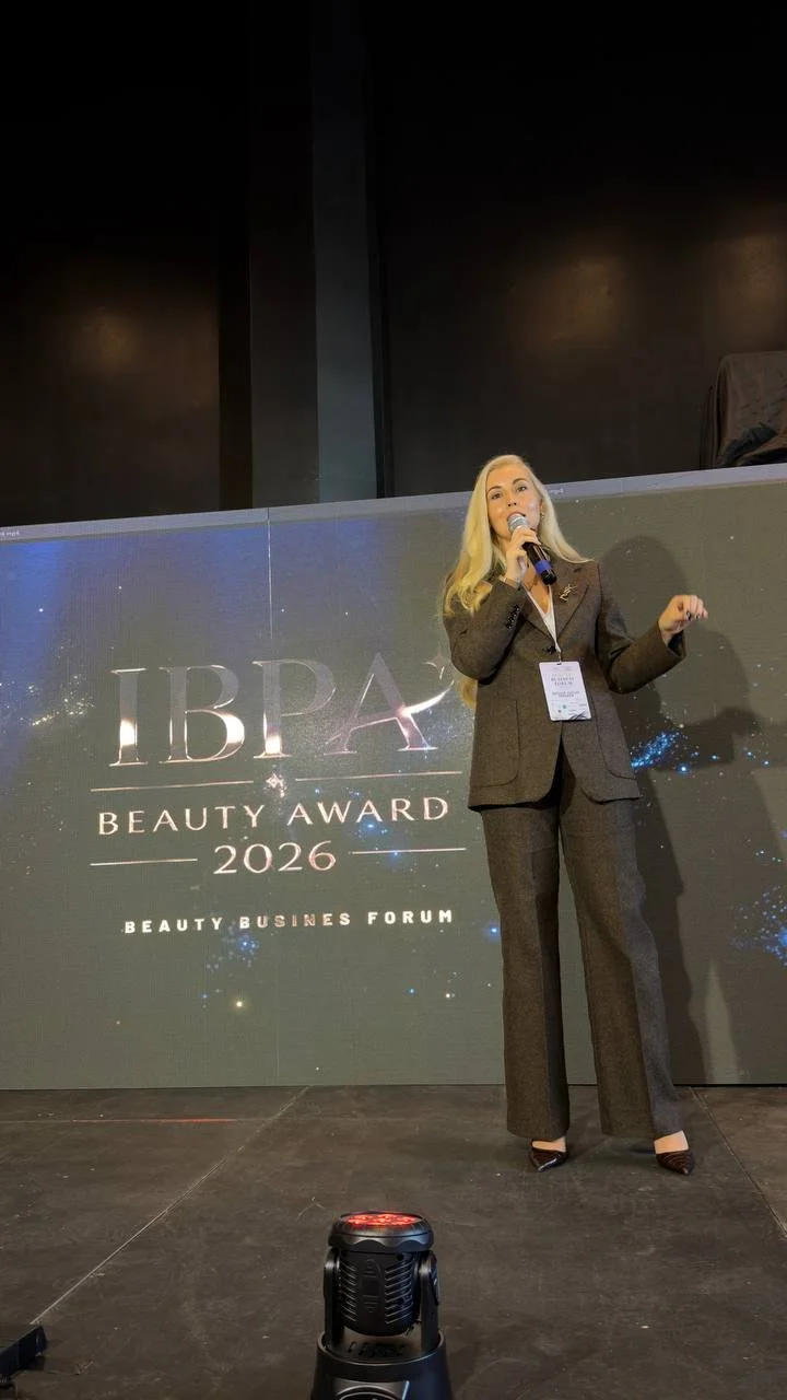 Natalie Vaulin speaking on stage at the Beauty Business Forum