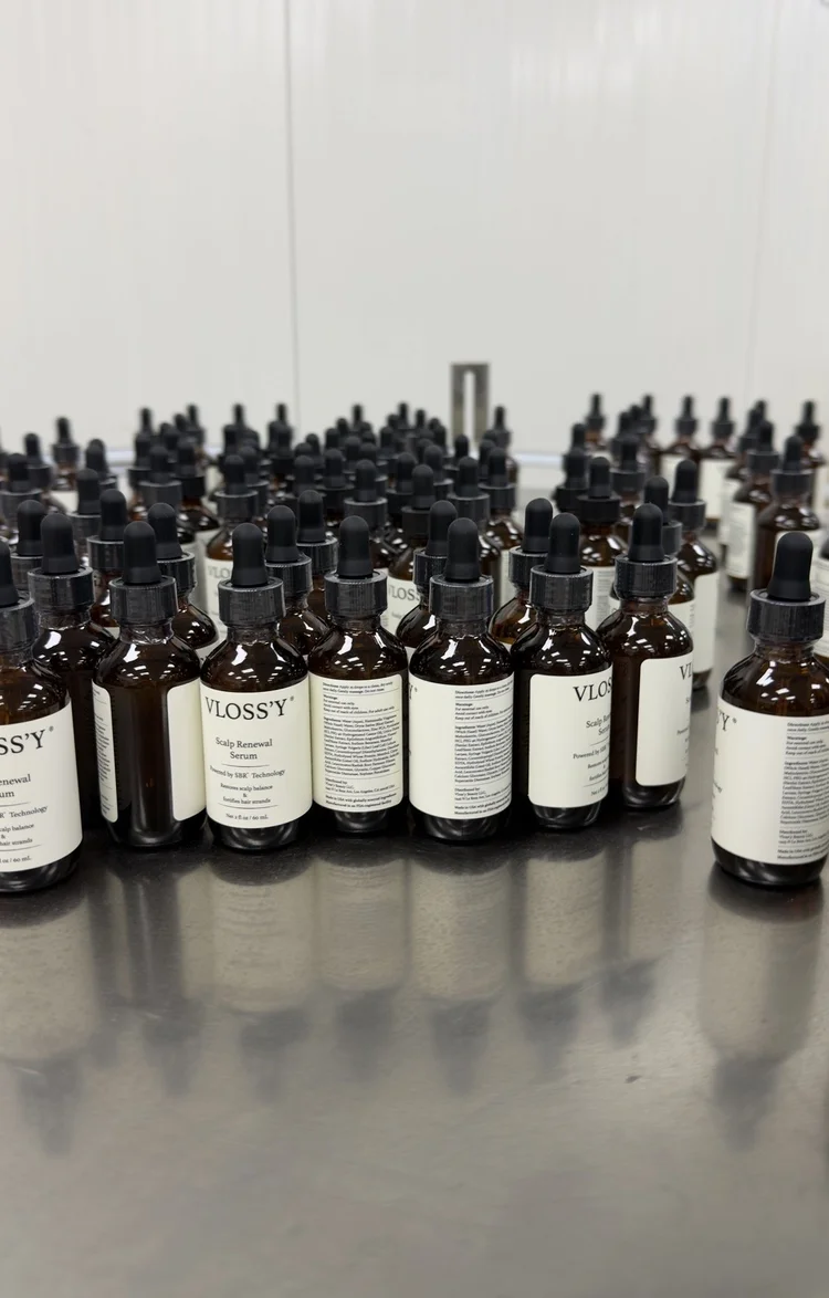 Amber dropper bottles of a scalp serum after filling