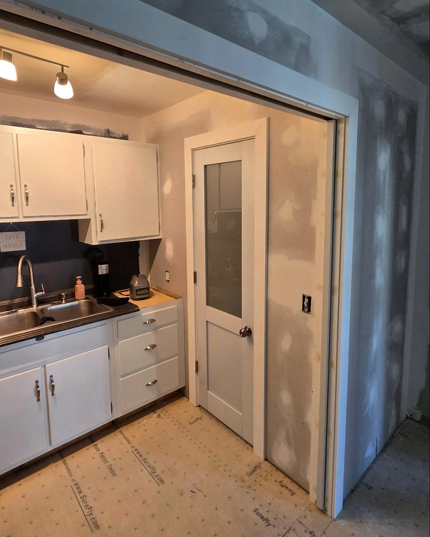 We recently converted a portion of this dining room into a divided room with a half bath and small kitchenette. Installed double pocket doors to close it off. 
The cramped kitchen wall was also opened up and we preformed another one of our specialtie