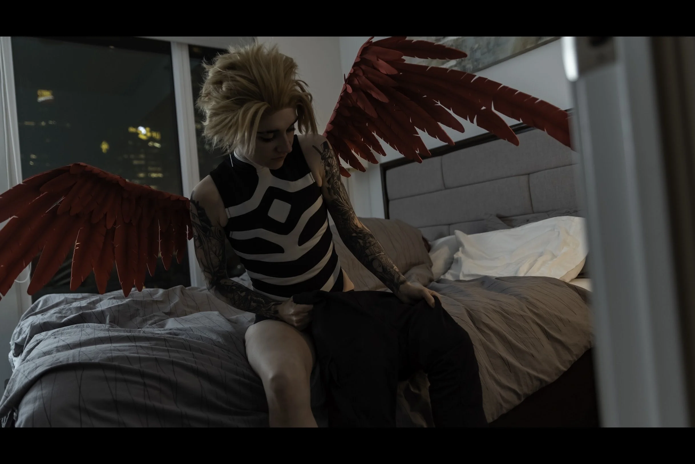 Hawks begins to get dressed carefully, pulling his pants on.